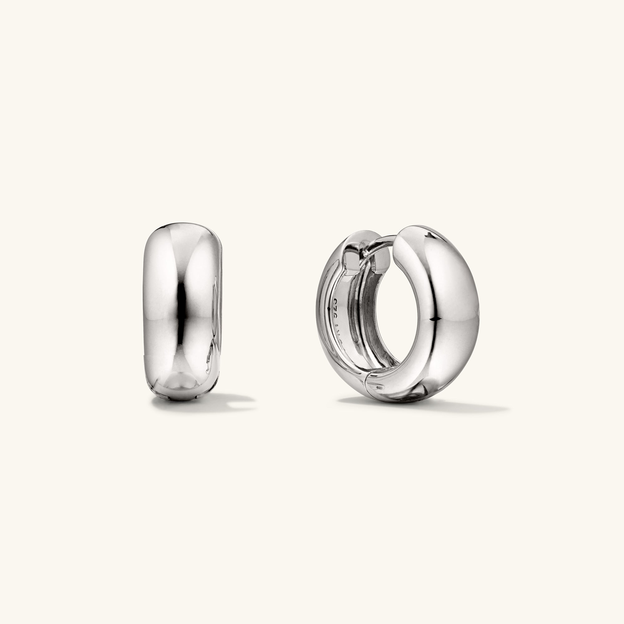 Chunky Medium Hoops: A pair of silver hoop earrings with a clicker closure, designed for comfort and secure stacking.