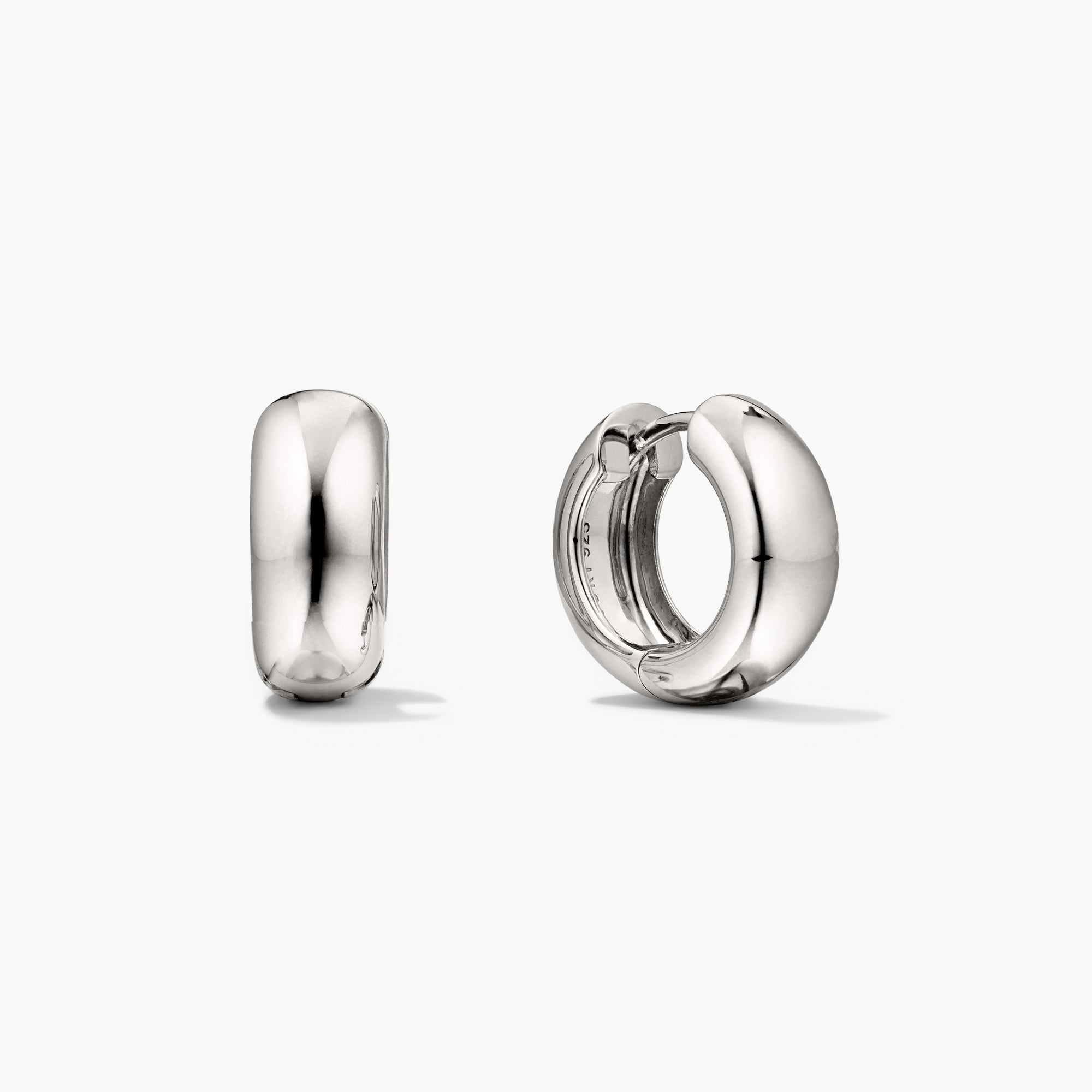 Chunky Medium Hoops: A pair of silver hoop earrings with a clicker closure, designed for comfort and secure stacking.