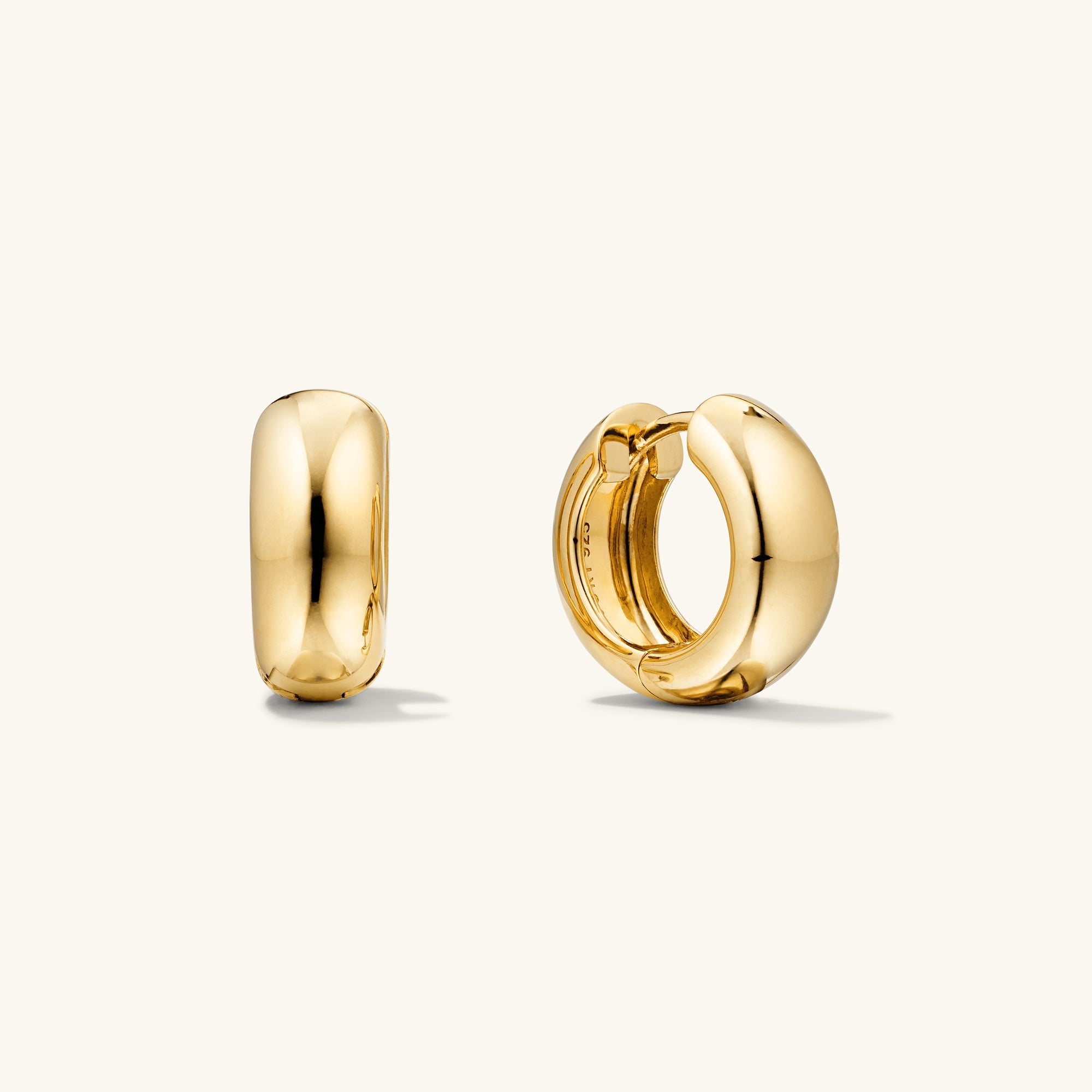 Chunky Medium Hoops: A pair of gold, pillowy hoop earrings with a secure clicker closure, perfect for comfortable wear and stylish stacking.