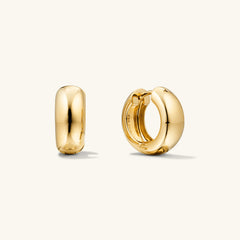 Chunky Medium Hoops: A pair of gold, pillowy hoop earrings with a secure clicker closure, perfect for comfortable wear and stylish stacking.