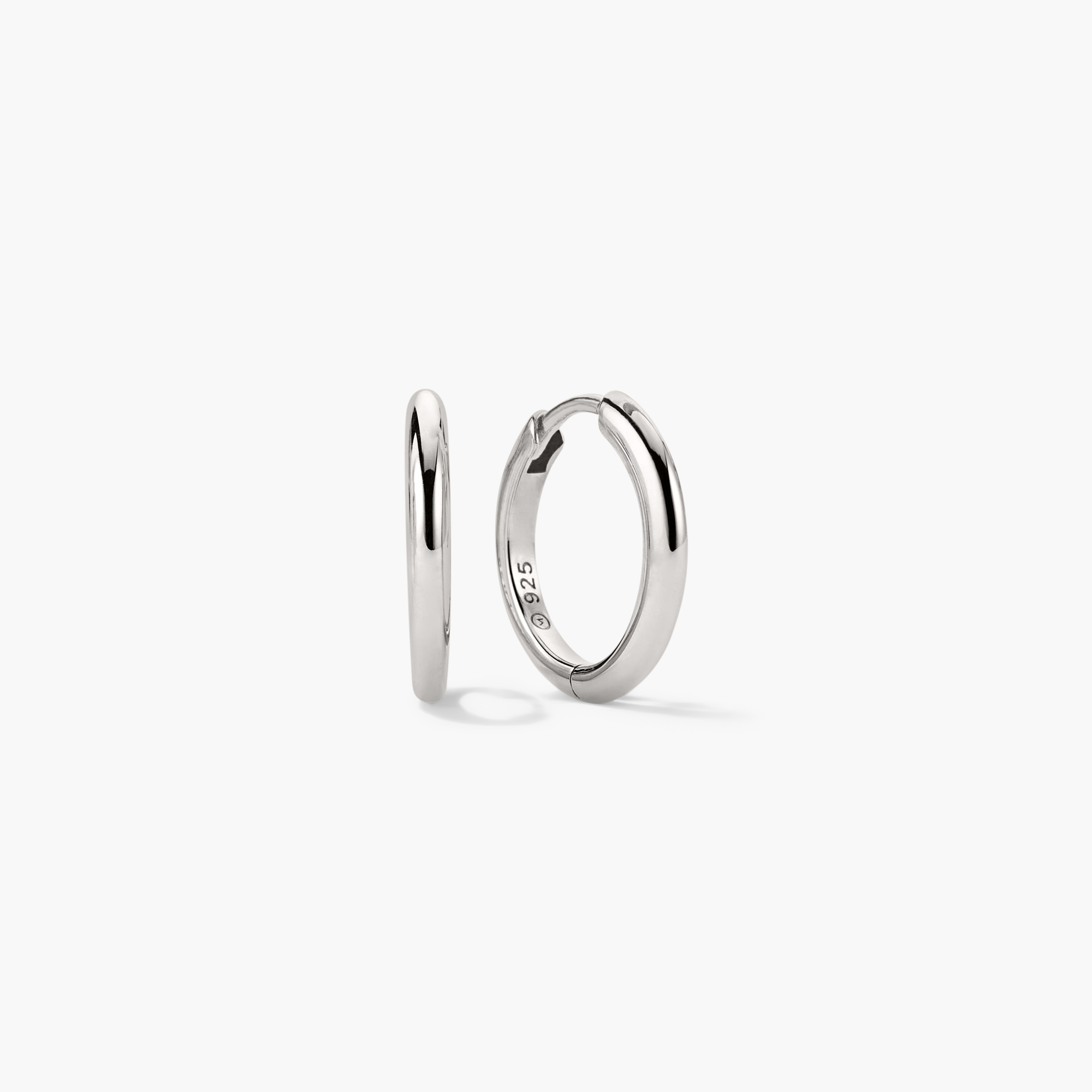 Tube Medium Hoops: Lightweight silver hoop earrings with a clicker closure for comfort and security, showcasing modern tubular design.