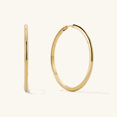 Tube Oversized Hoops: Modern, lightweight gold hoop earrings with a clicker closure for comfort and security, perfect for everyday wear.