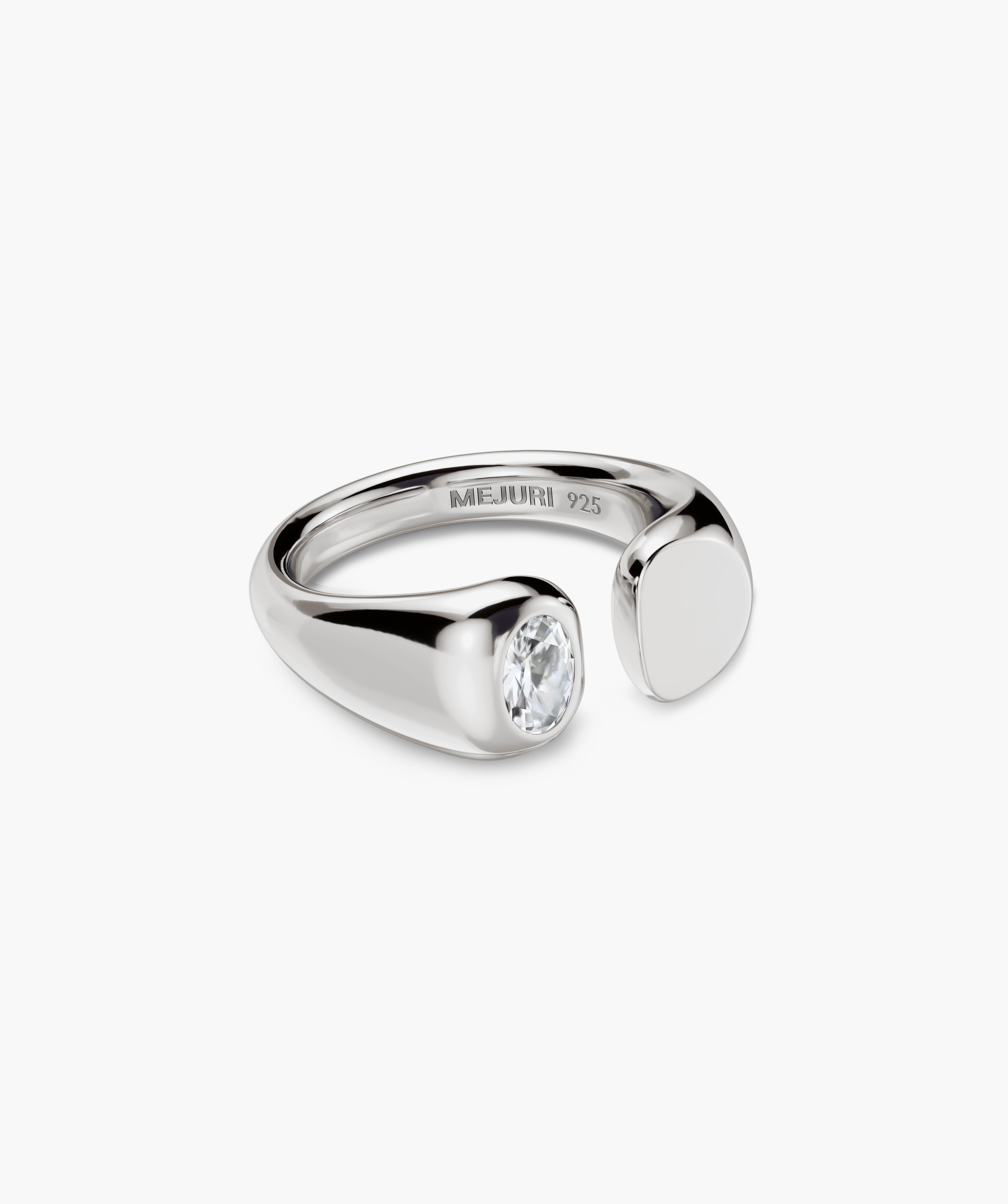 Noa Open Signet Pinky Ring features a sterling-silver open band with a clear stone on one end and a polished metal pad on the other.