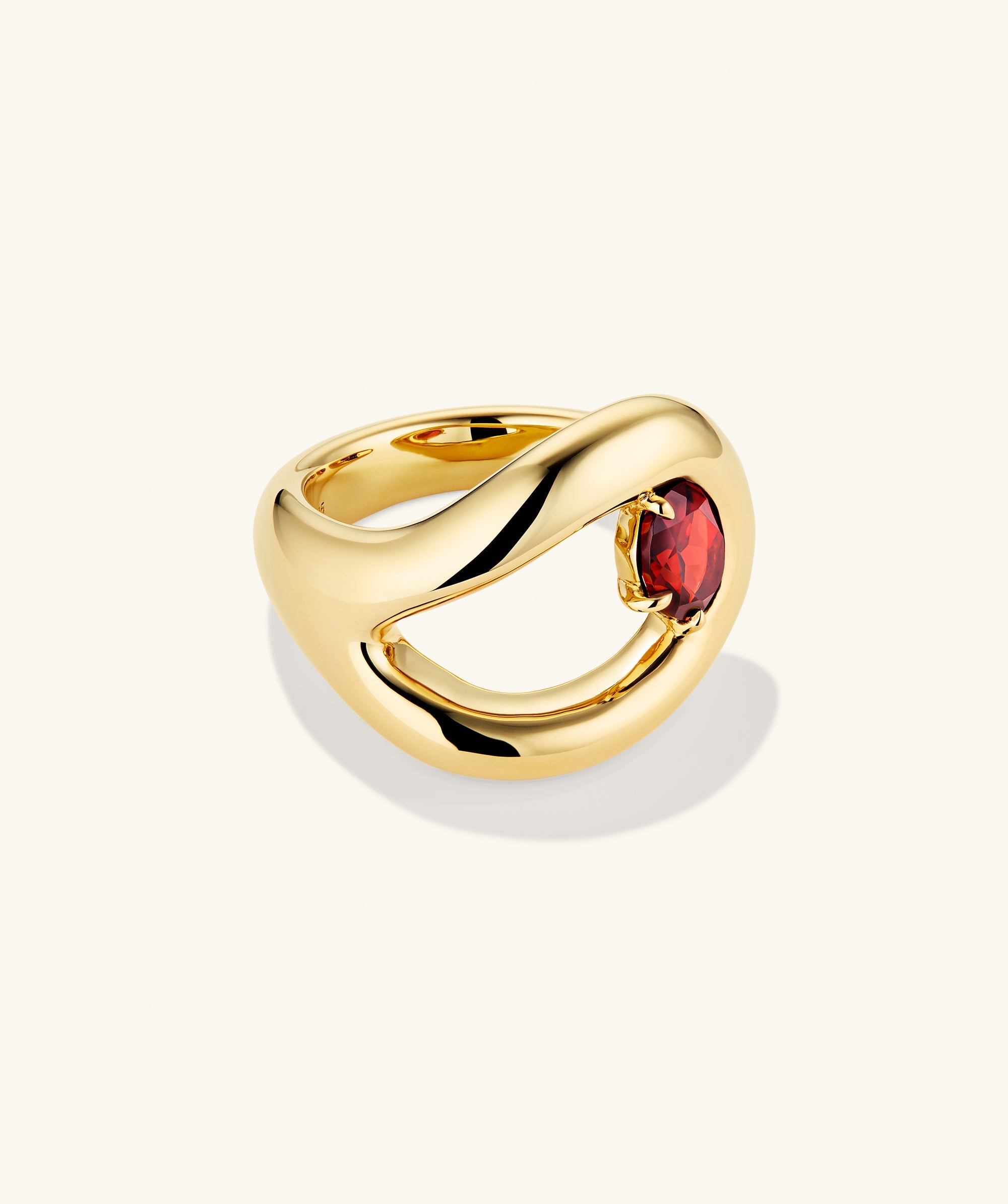 Organic DÃ´me Curve Gemstone Ring featuring a gold band and a prominent red stone, showcasing unique organic curves for an elegant addition to your jewelry collection.