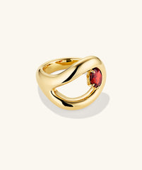 Organic DÃ´me Curve Gemstone Ring featuring a gold band and a prominent red stone, showcasing unique organic curves for an elegant addition to your jewelry collection.