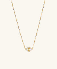 PavÃ© Diamond Evil Eye Necklace featuring a delicate gold chain with a small eye pendant, designed to ward off envy and negative energy.