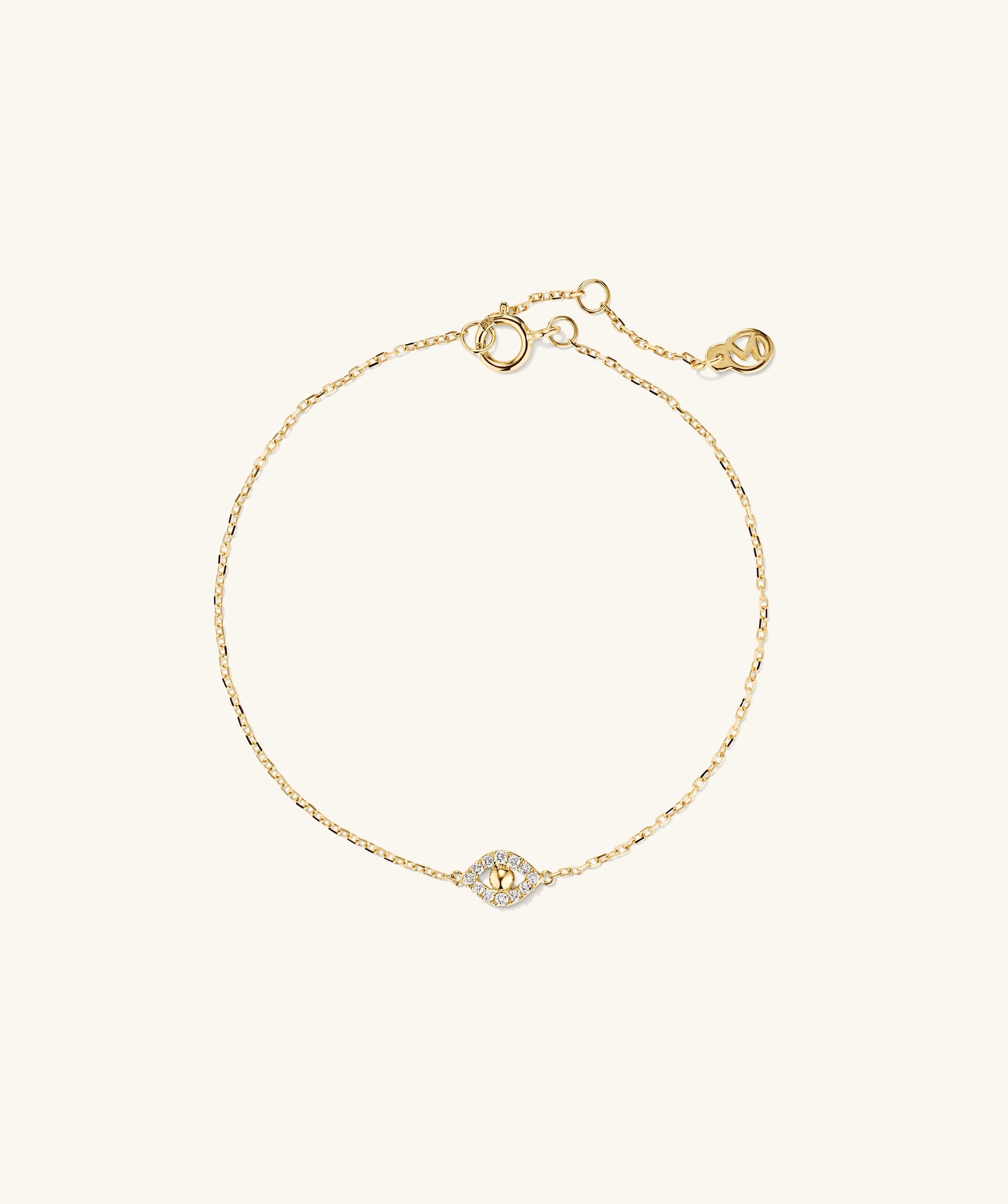 PavÃ© Diamond Evil Eye Bracelet featuring a gold band adorned with a diamond-studded evil eye pendant, symbolizing protection against negativity.