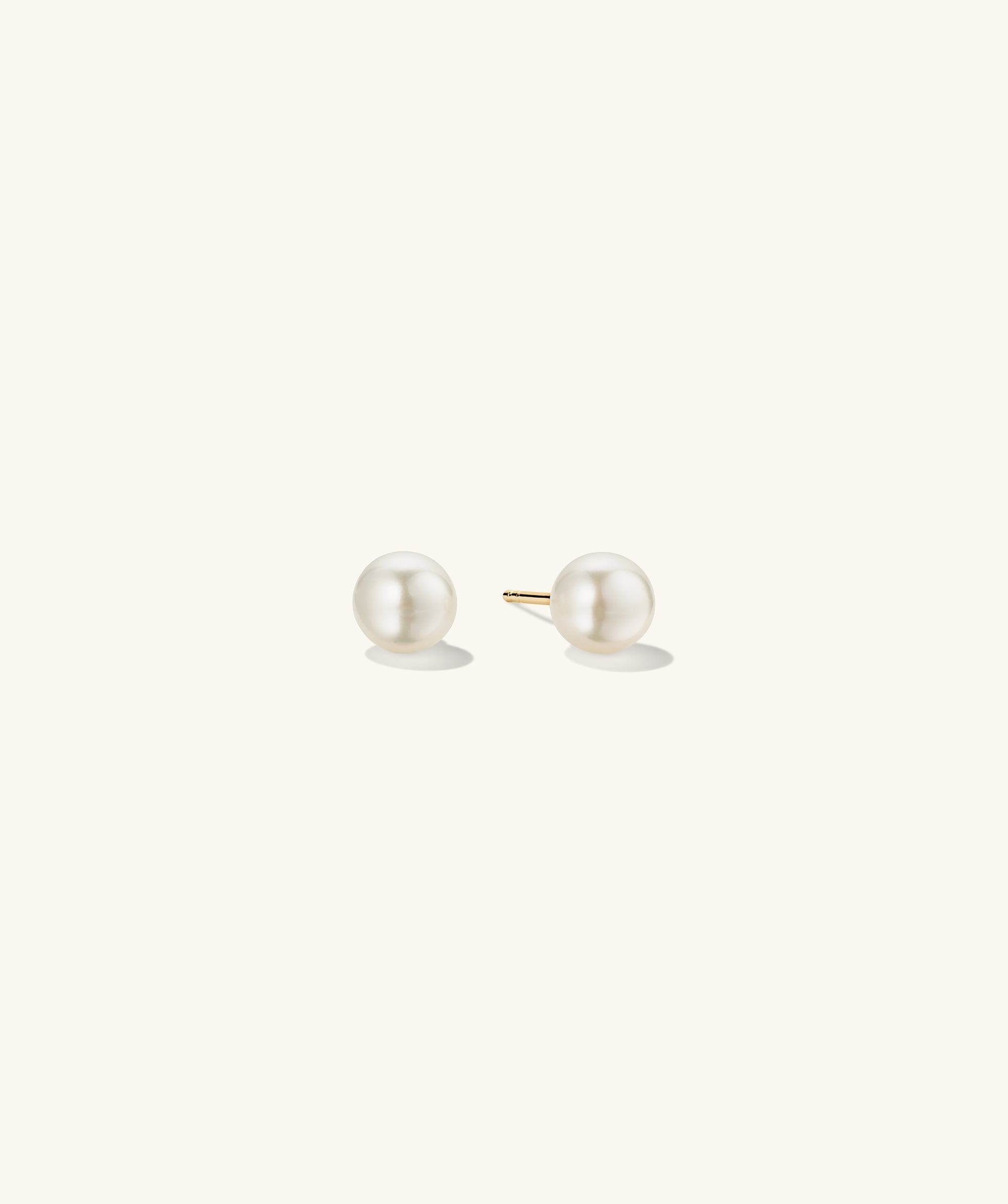 Pearl Oversized Studs: Close-up view of handcrafted 18k gold vermeil earrings featuring freshwater pearls.
