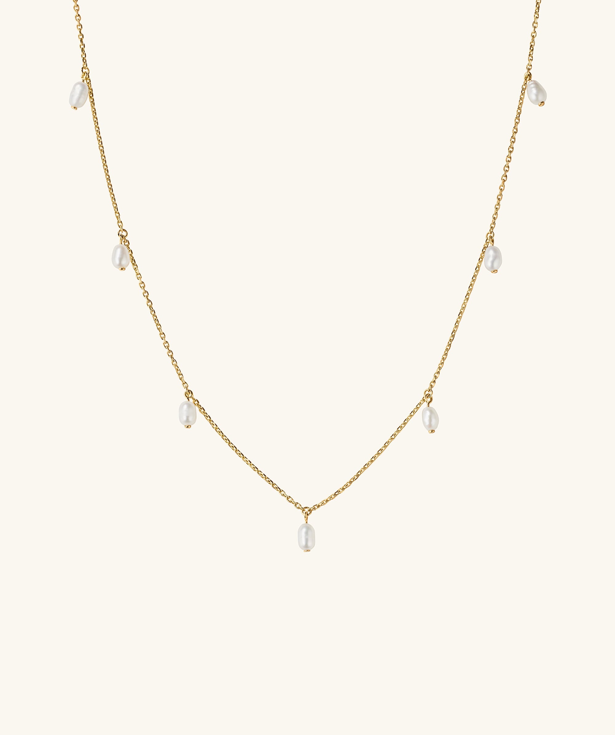 Tiny Pearl Station Necklace: An 18k gold vermeil chain adorned with evenly spaced freshwater pearls, showcasing a delicate and elegant design.