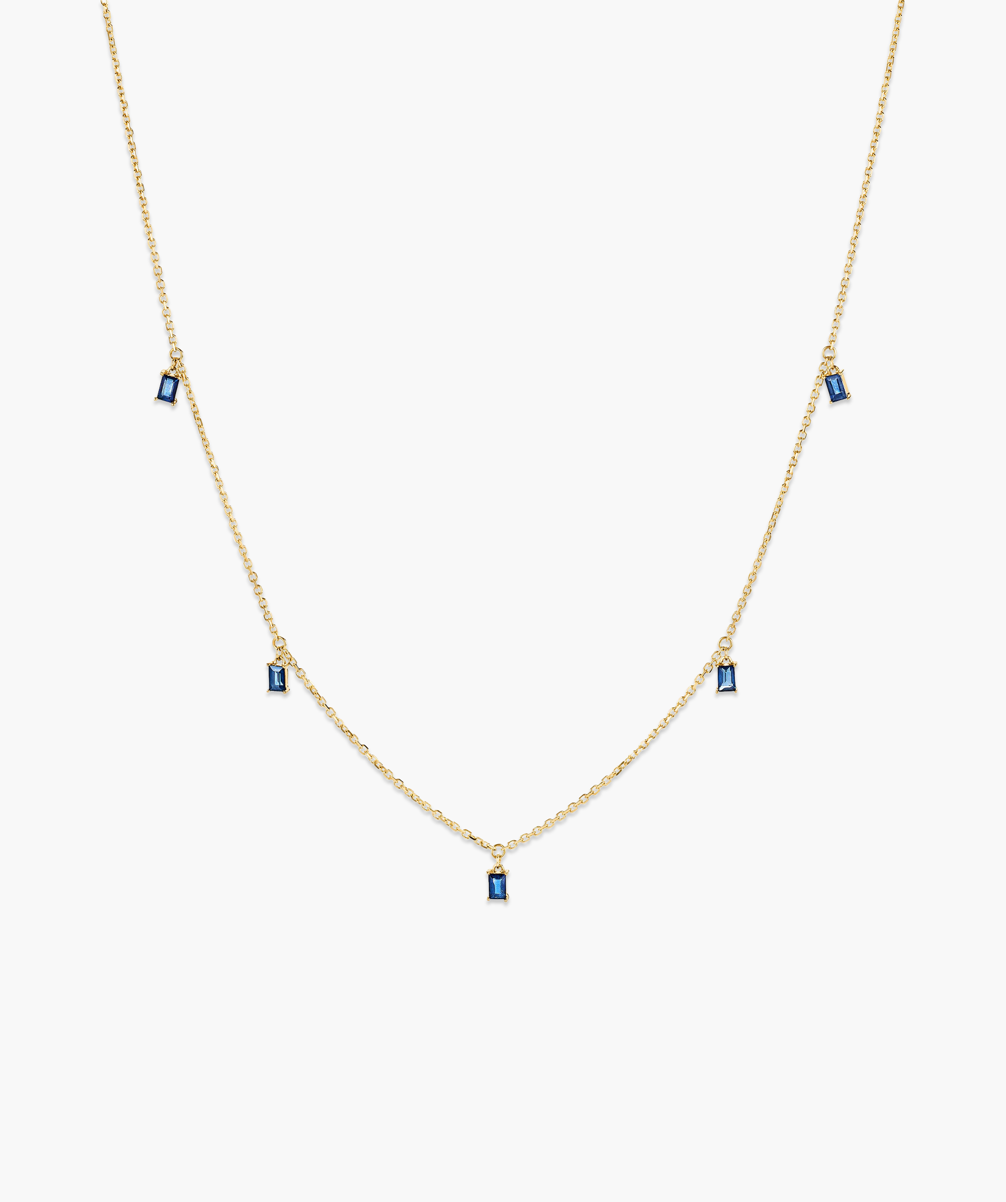 Baguette Gemstone Station Necklace: A gold chain adorned with evenly spaced blue stones, perfect for creating standout jewelry stacks and adding a touch of elegance.