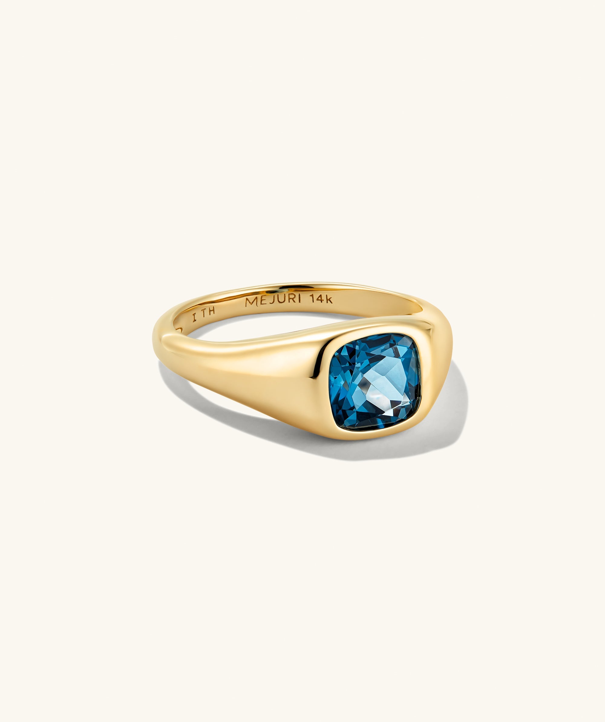 Jude Pinky Signet Ring features a 14K yellow-gold band with a cushion-cut blue gemstone, engraved inside with âMEJURI 14k.â