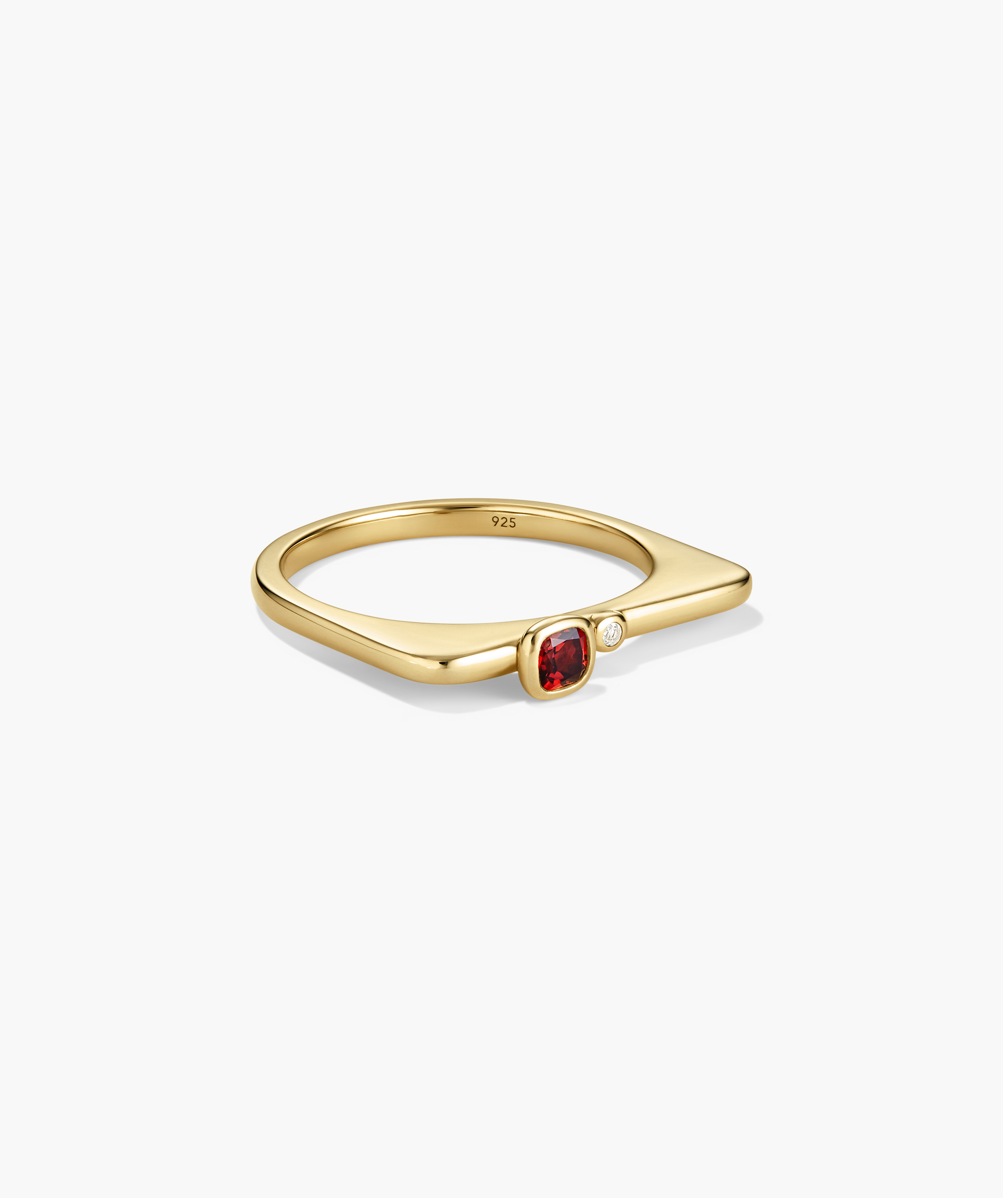 Puzzle Stacking Ring: A V-shaped gold ring with a sterling silver core, featuring a cushion-cut red gem and clear round accent stone.