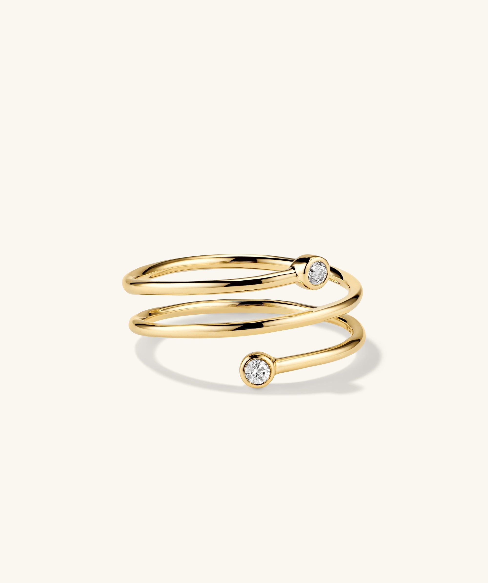 Diamond Coil Ring: Handcrafted 14k gold ring featuring responsibly sourced pavÃ© diamonds, designed to give the appearance of multiple rings in one.