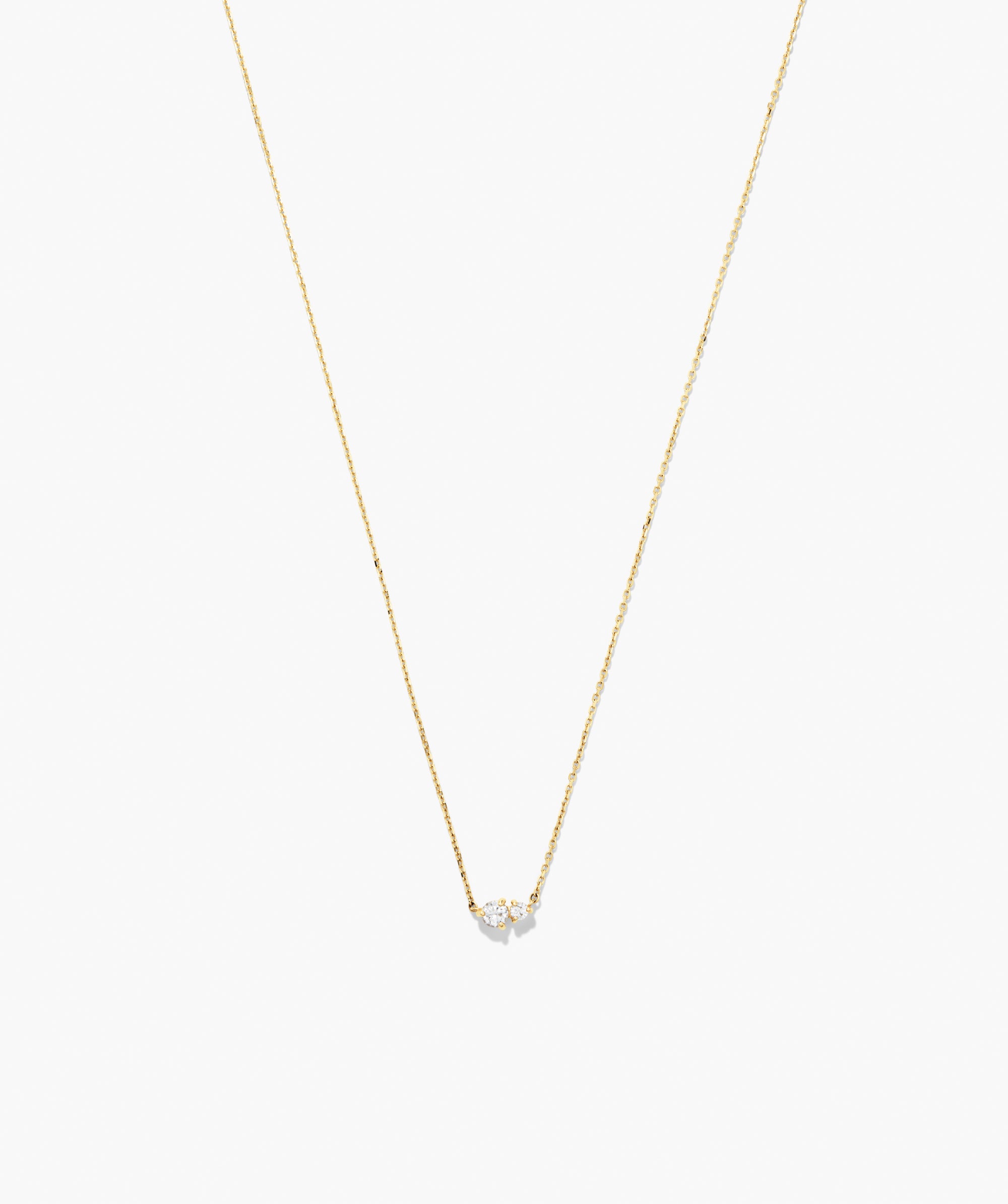 Beverly Necklace: A delicate gold chain featuring a small cluster of sparkling stones, perfect for wearing solo or layered with other necklaces.