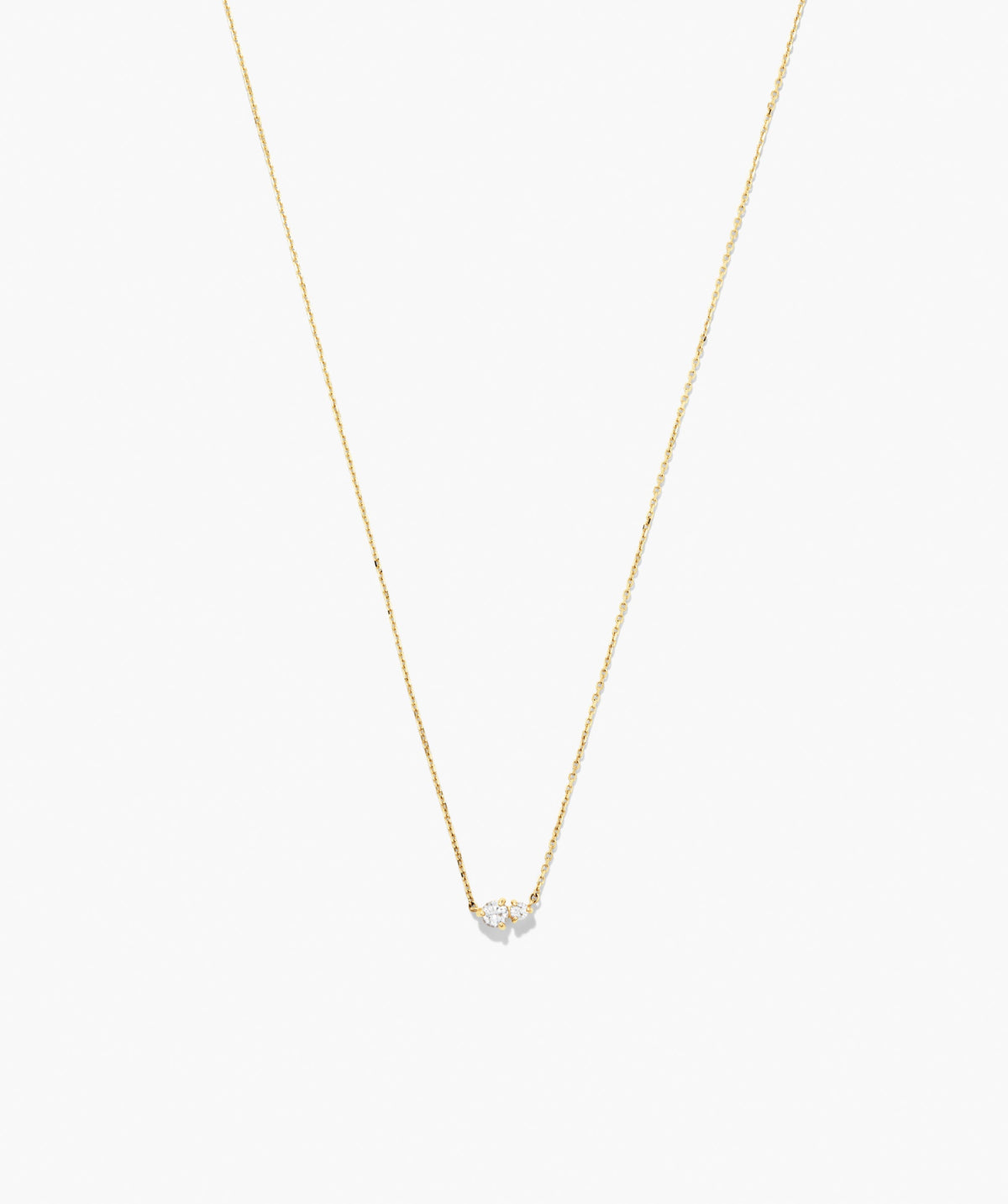 Beverly Necklace: A delicate gold chain featuring a small cluster of sparkling stones, perfect for wearing solo or layered with other necklaces.