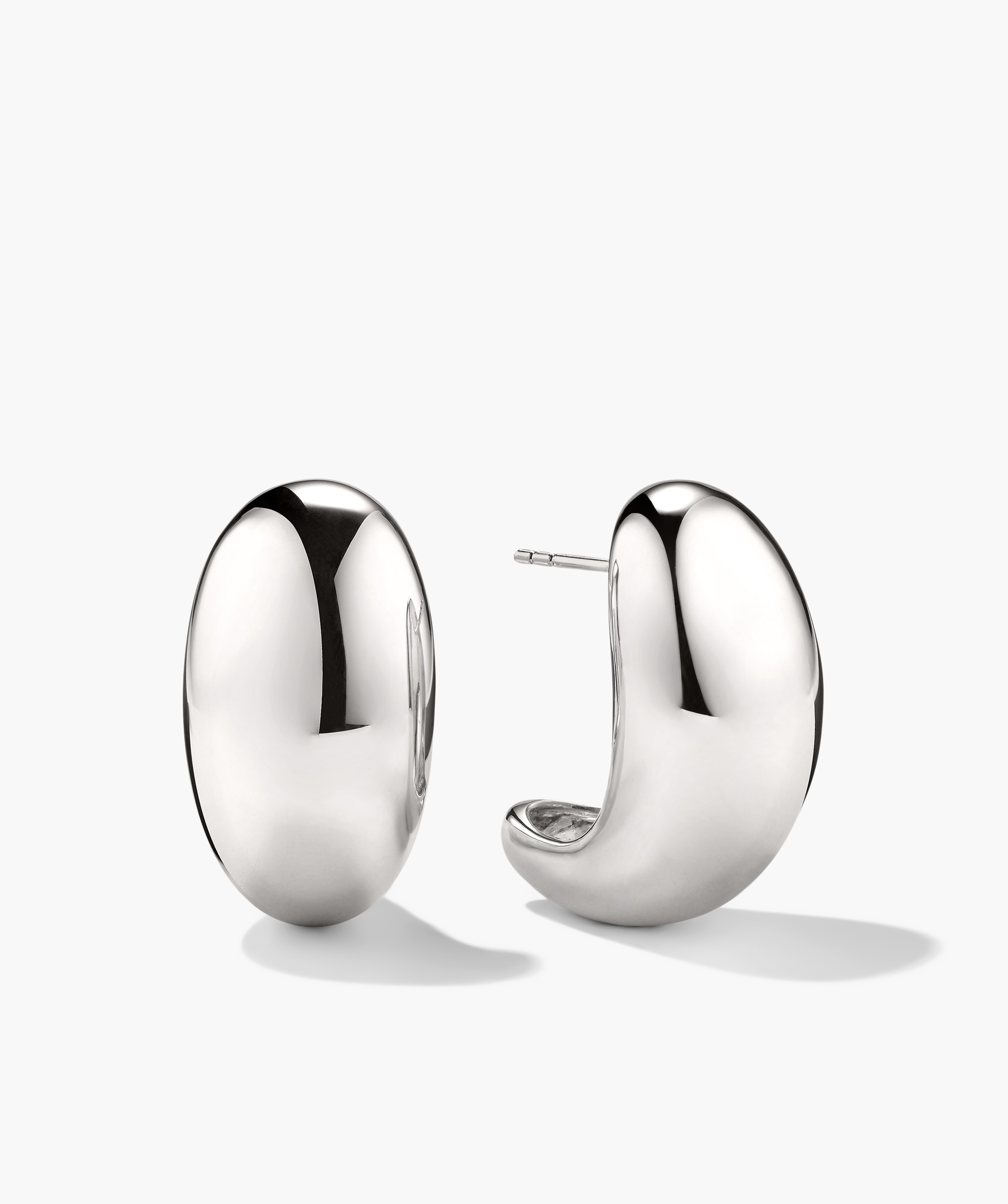 Mega DÃ´me Earrings: A pair of large, shiny silver earrings designed with a bold, puffed shape, part of the DÃ´me collection, commanding attention effortlessly.