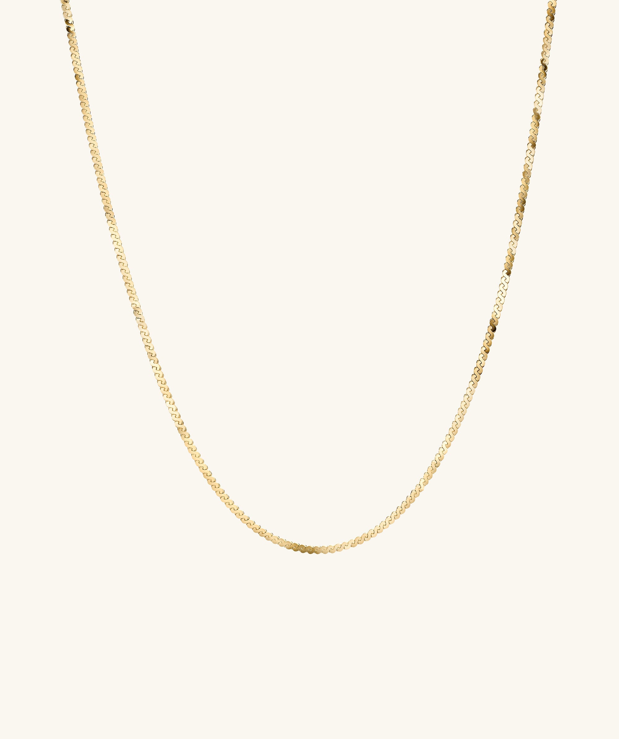 Serpentine Chain Necklace: A sleek gold chain, minimal yet striking, perfect for any occasion, shown on a white background.