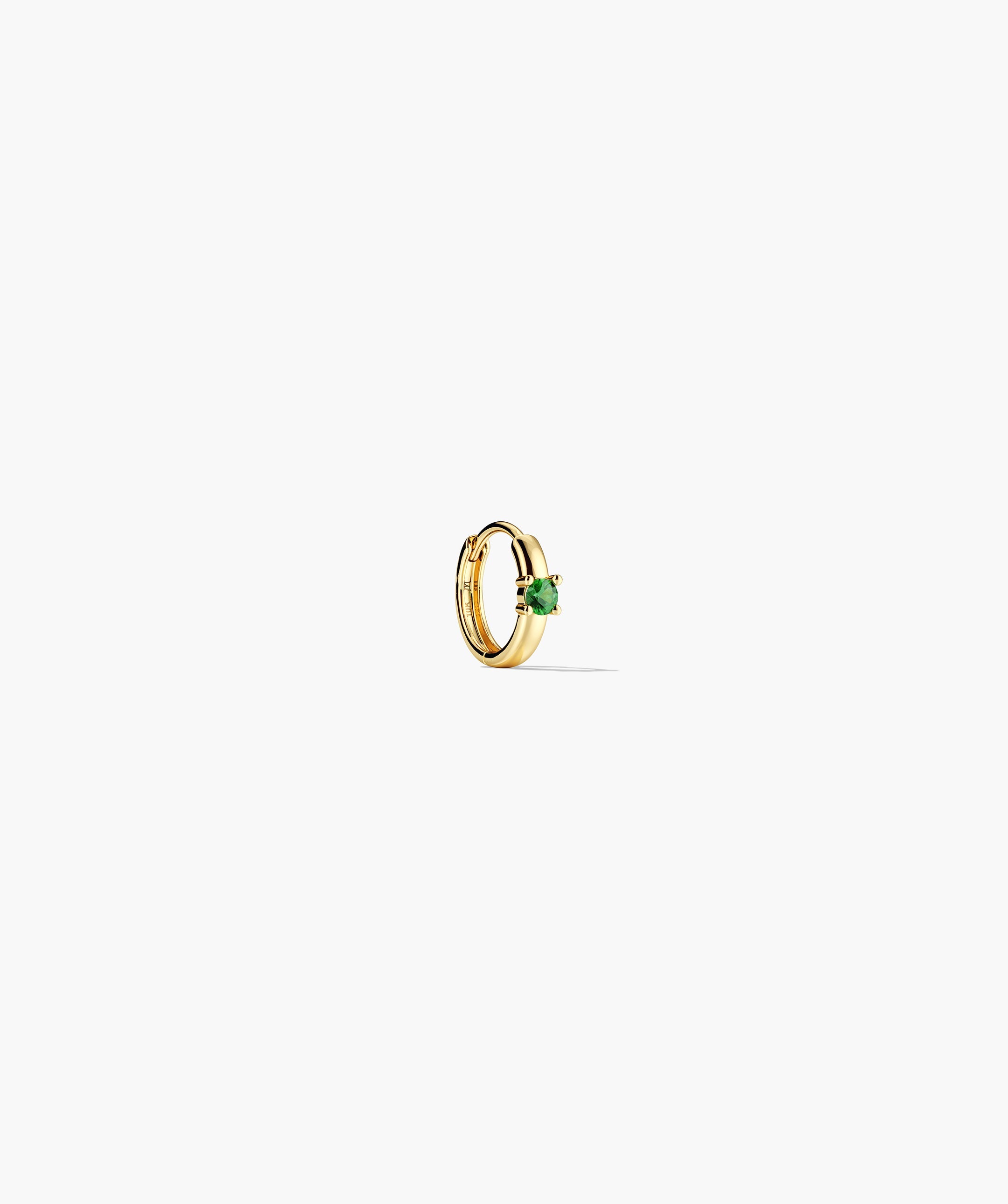 Single Colored Mini Hoop: Small gold huggie earring with a round green gemstone and hinge clasp, designed for everyday comfort. Sold individually.