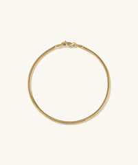 Cobra Bracelet: A gold chain with a clasp, showcasing intricate links, designed as a fashionable body jewelry piece.