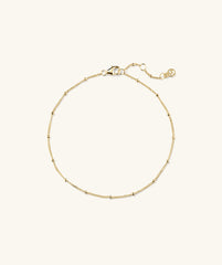 Gold Spheres Bracelet with a clasp, featuring a minimalist design, suitable for any occasion.