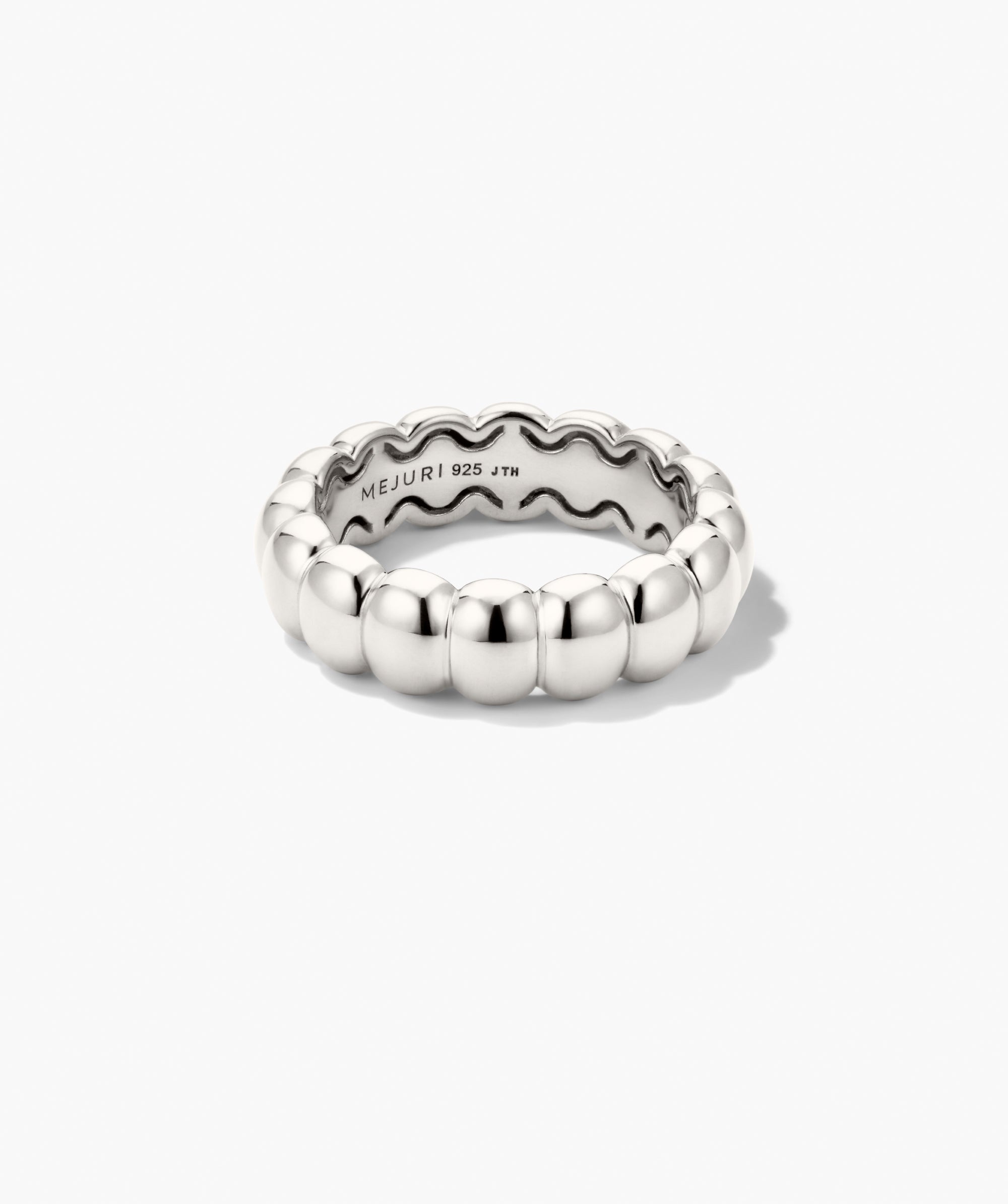 Puffy Charlotte Stacker Ring: A polished sterling-silver band of smooth, rounded bubbles, engraved inside with âMEJURI 925 JTM,â offering iconic, glossy elegance.