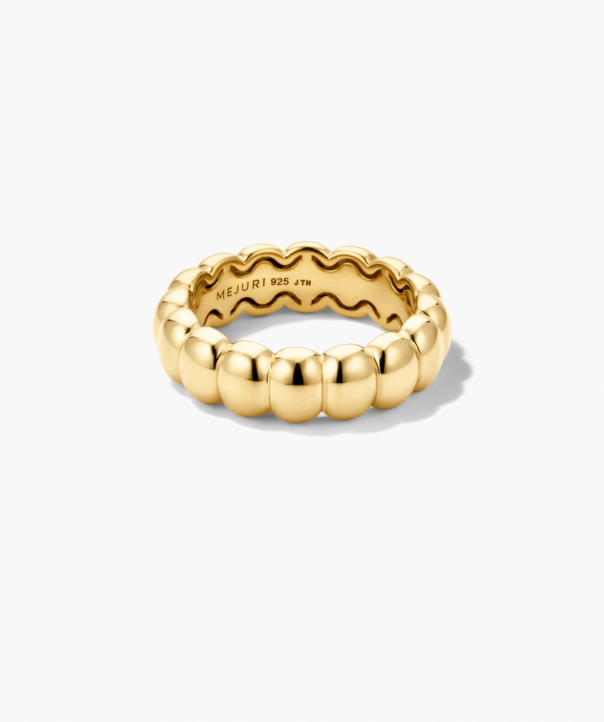 Puffy Charlotte Stacker Ring: A gold-plated sterling silver ring with rounded, pill-shaped beads, showcasing Mejuri's iconic design and glossy finish. Stamped âMEJURI 925 JTHâ inside.