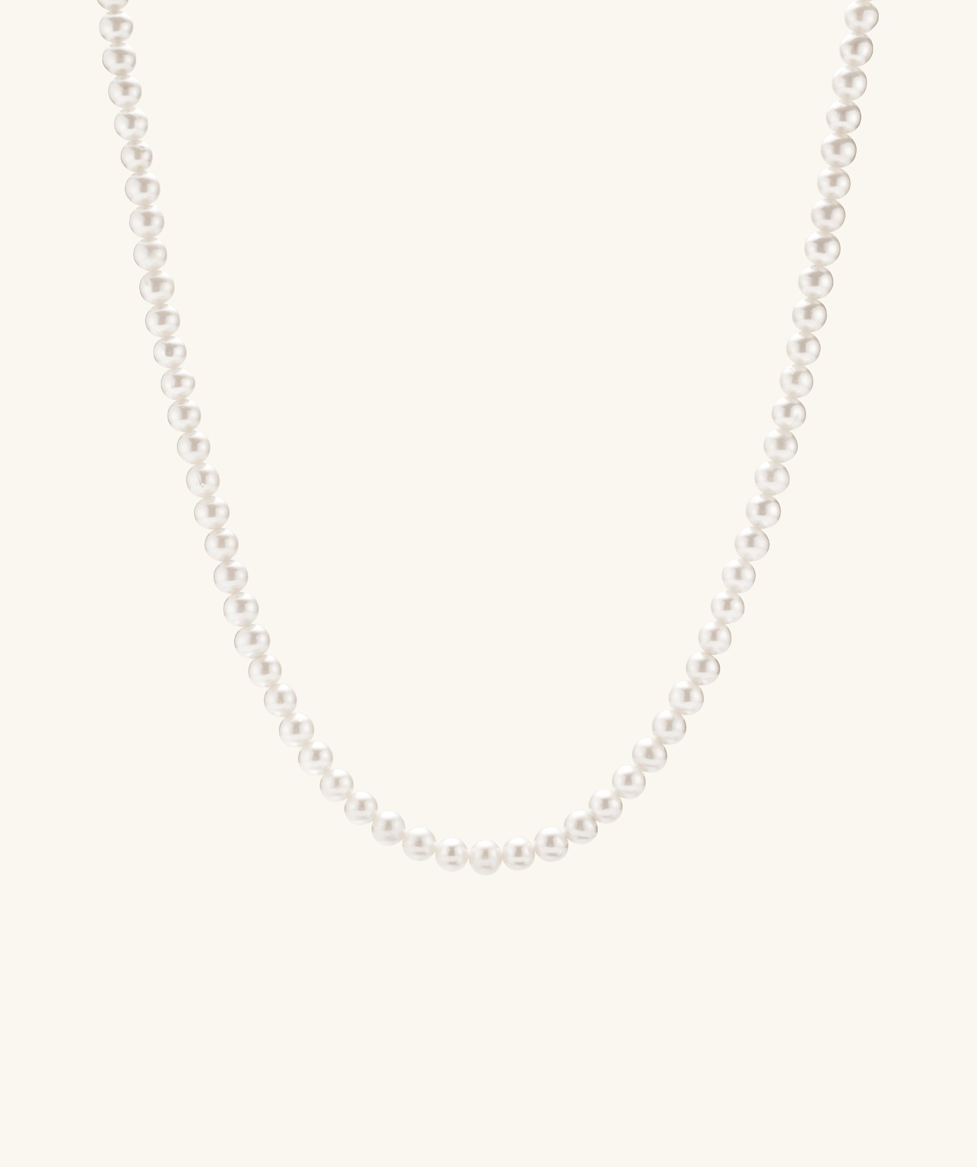 Close-up of the Paradigm Pearl Necklace, showcasing handcrafted freshwater pearls on a delicate chain with a sterling silver clasp.