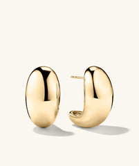 Mega DÃ´me Earrings: A pair of large, gold, puffed earrings, designed to capture attention with their bold, standout style.