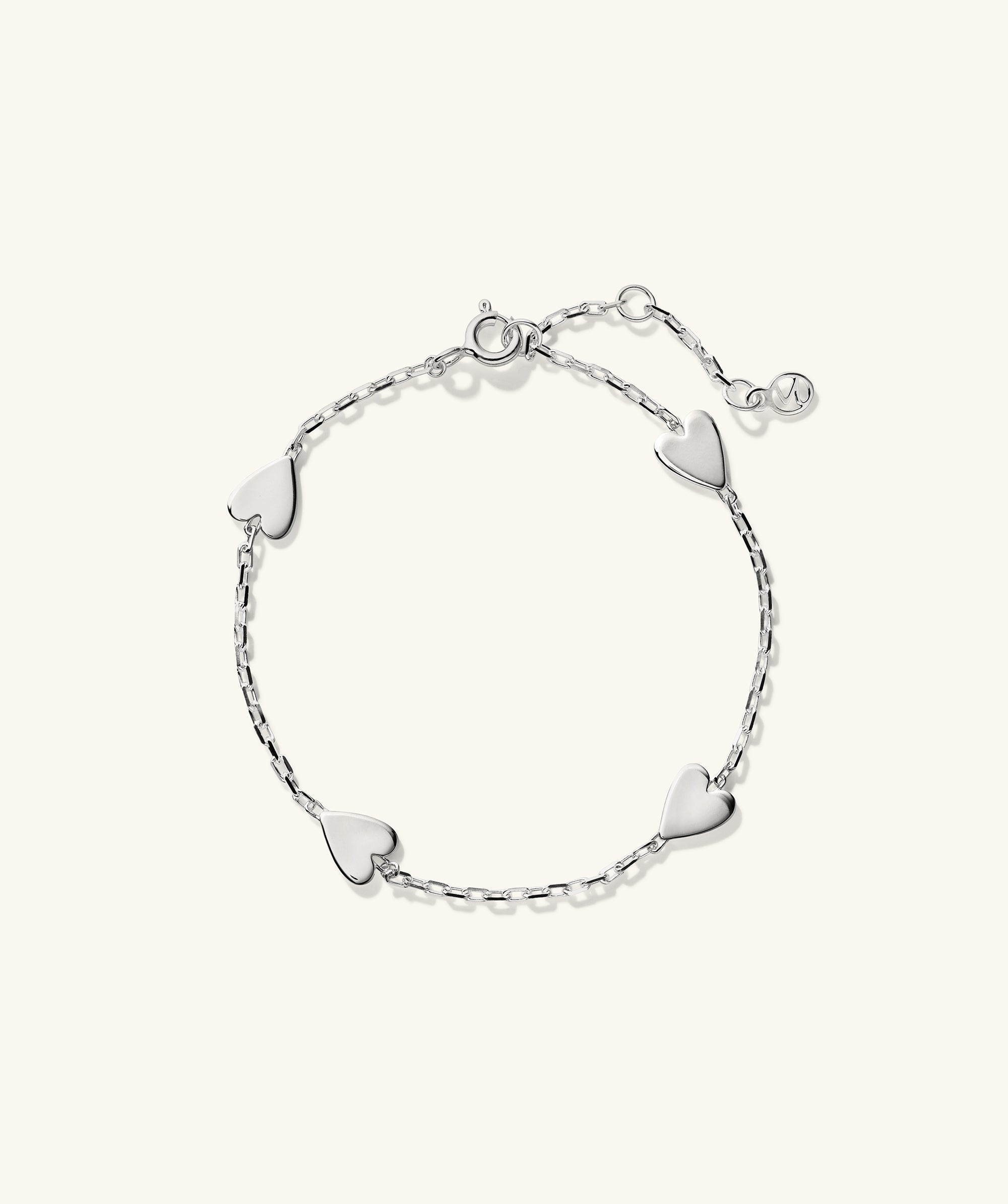 Heart Station Bracelet: A silver bracelet adorned with multiple heart-shaped charms.