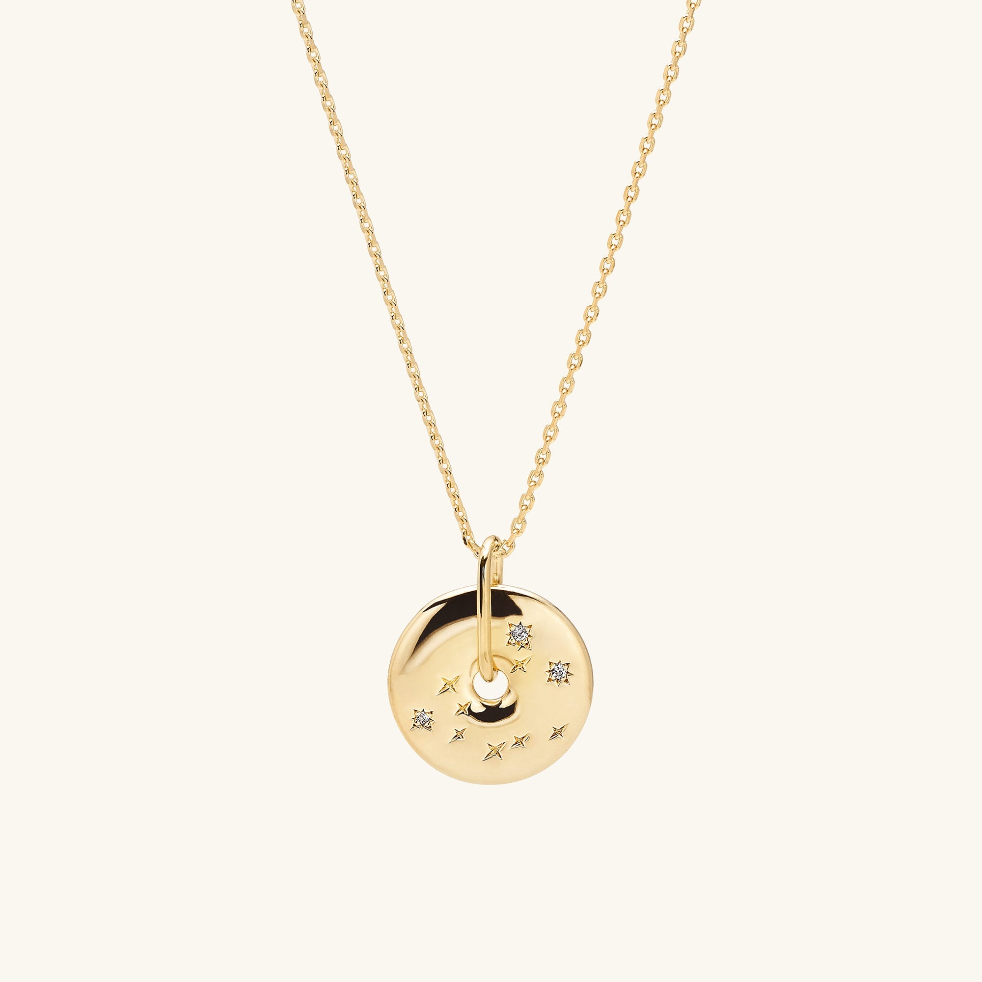 Zodiac Pendant Necklace featuring an 18k gold vermeil disc with white sapphire gemstones, handcrafted and designed with a constellation motif on a delicate gold chain.