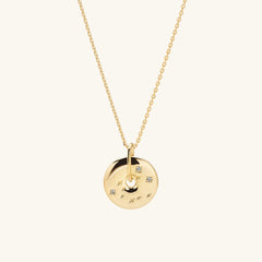 Zodiac Pendant Necklace featuring an 18k gold vermeil disc with white sapphire gemstones, handcrafted and designed with a constellation motif on a delicate gold chain.