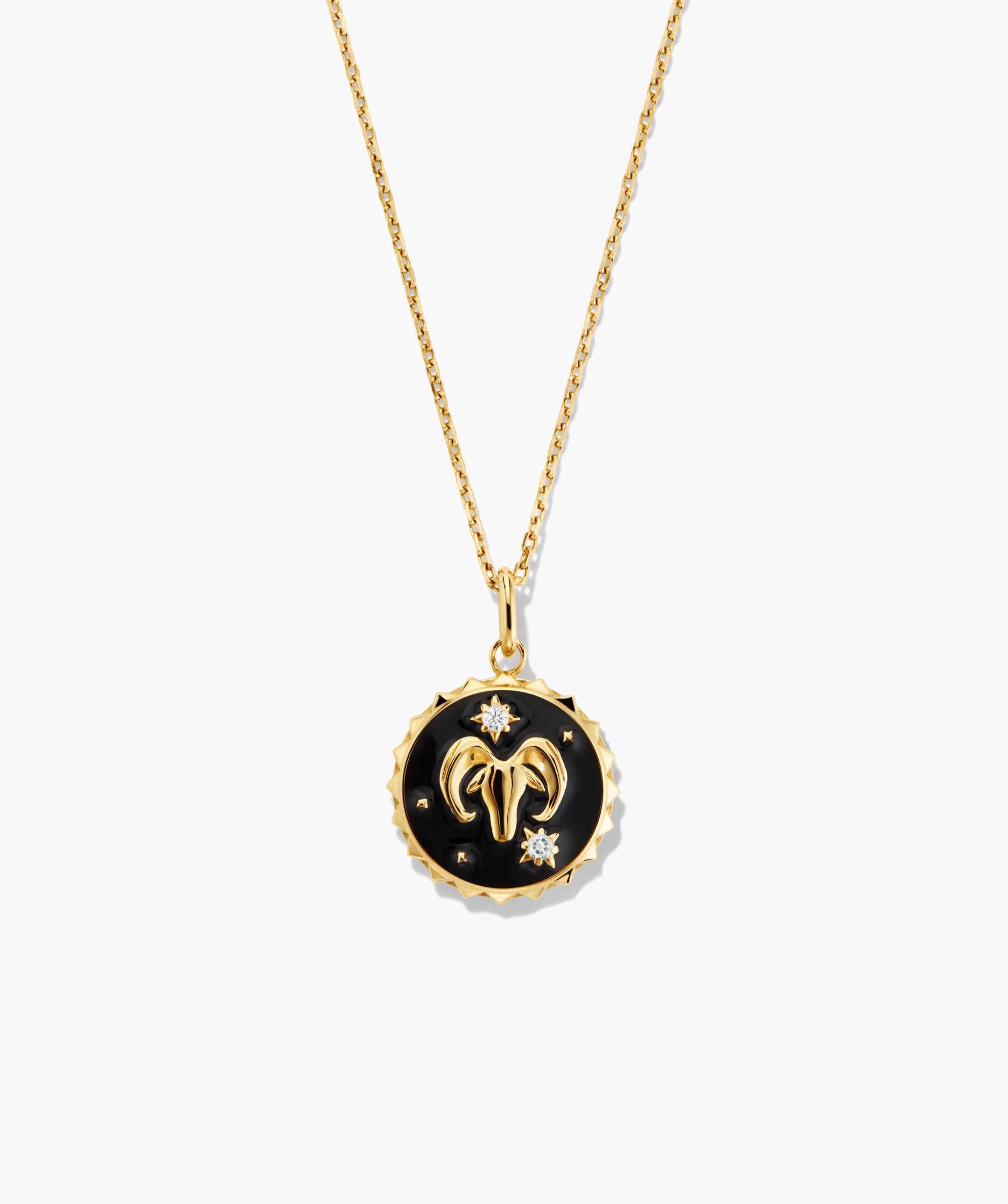 Cosmic Pendant Necklace with a gold-plated chain features a black-enameled medallion with an Aries ramâs-horn motif and star-like diamond accents.