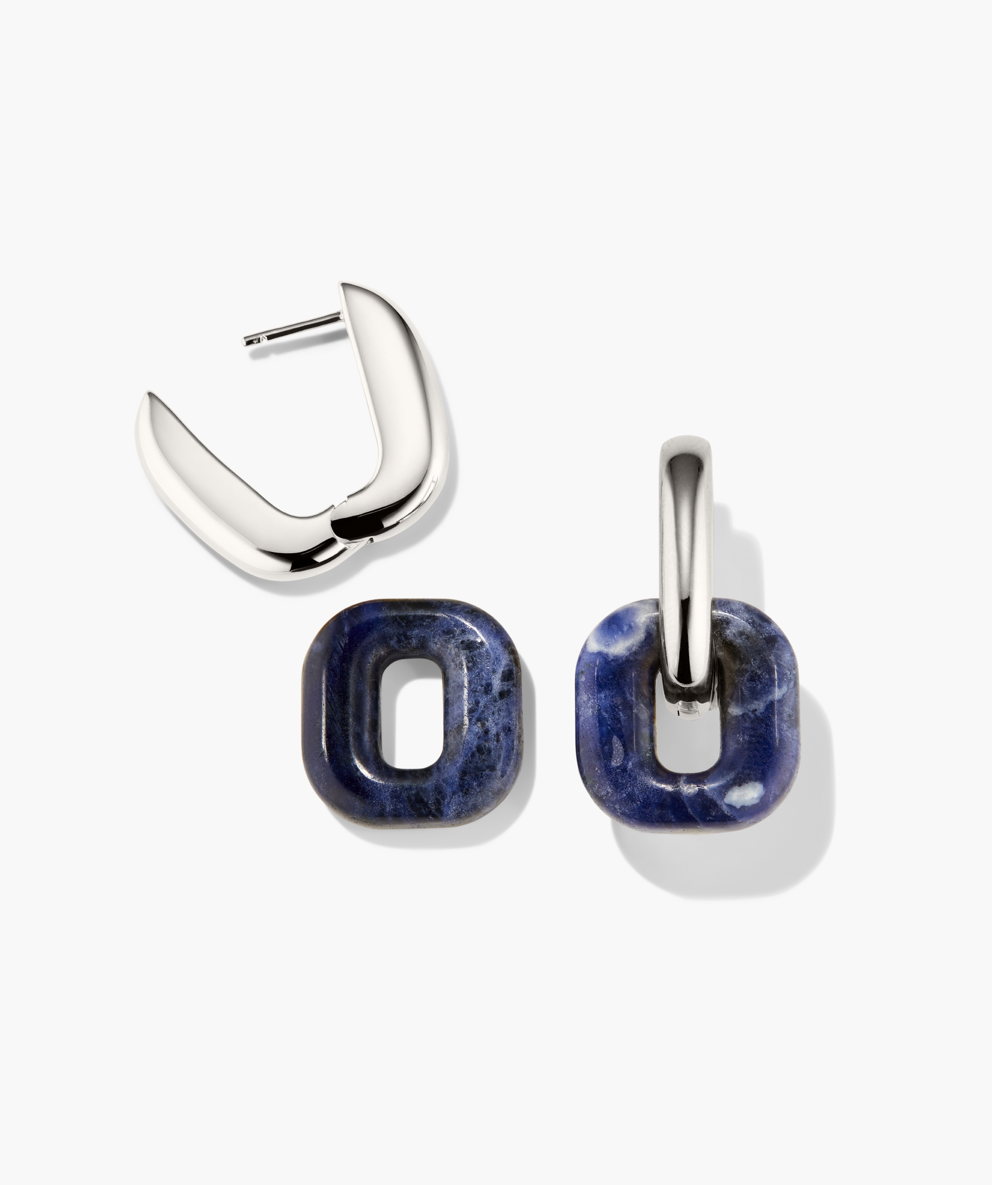 Stevie Hoops earrings in polished silver featuring interchangeable deep blue stone charms, demonstrating versatility with one hoop open and one charm attached.
