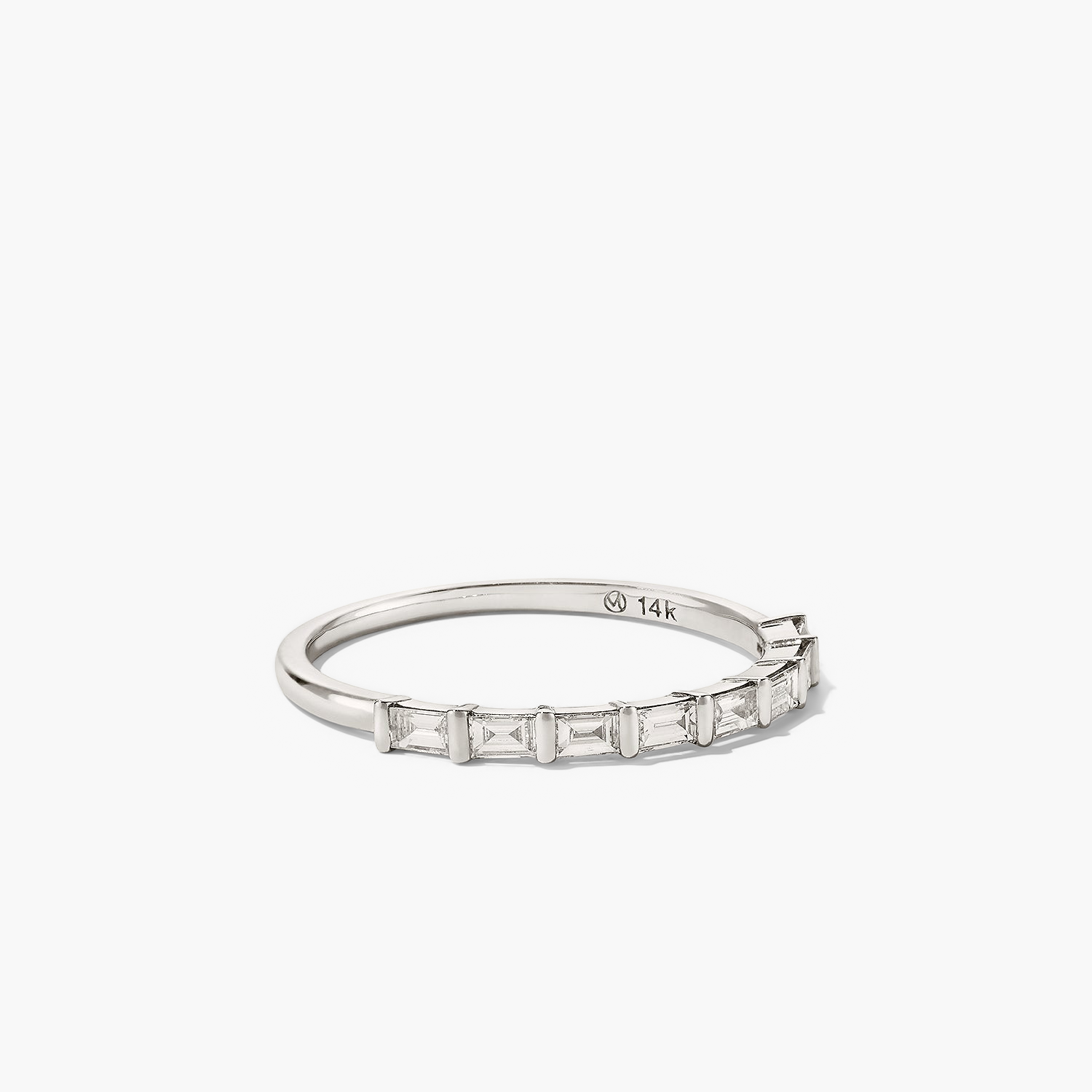 Baguette Diamond Half Eternity Band â a close-up of a silver ring featuring eight baguette diamonds set in a timeless band.