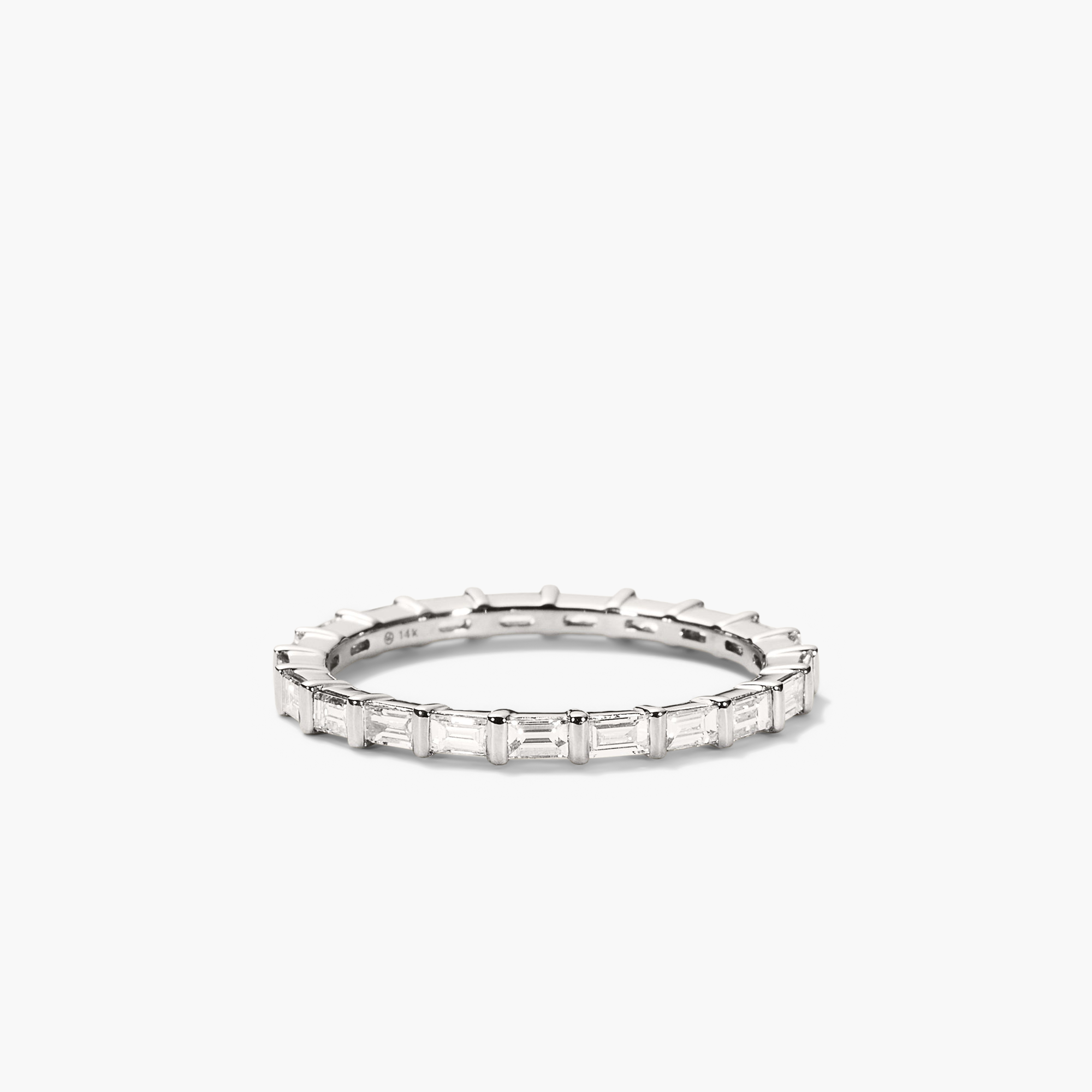 Baguette Diamond Eternity Band: A close-up of a silver ring adorned with baguette diamonds, handcrafted in 14k solid gold, showcasing its timeless elegance.