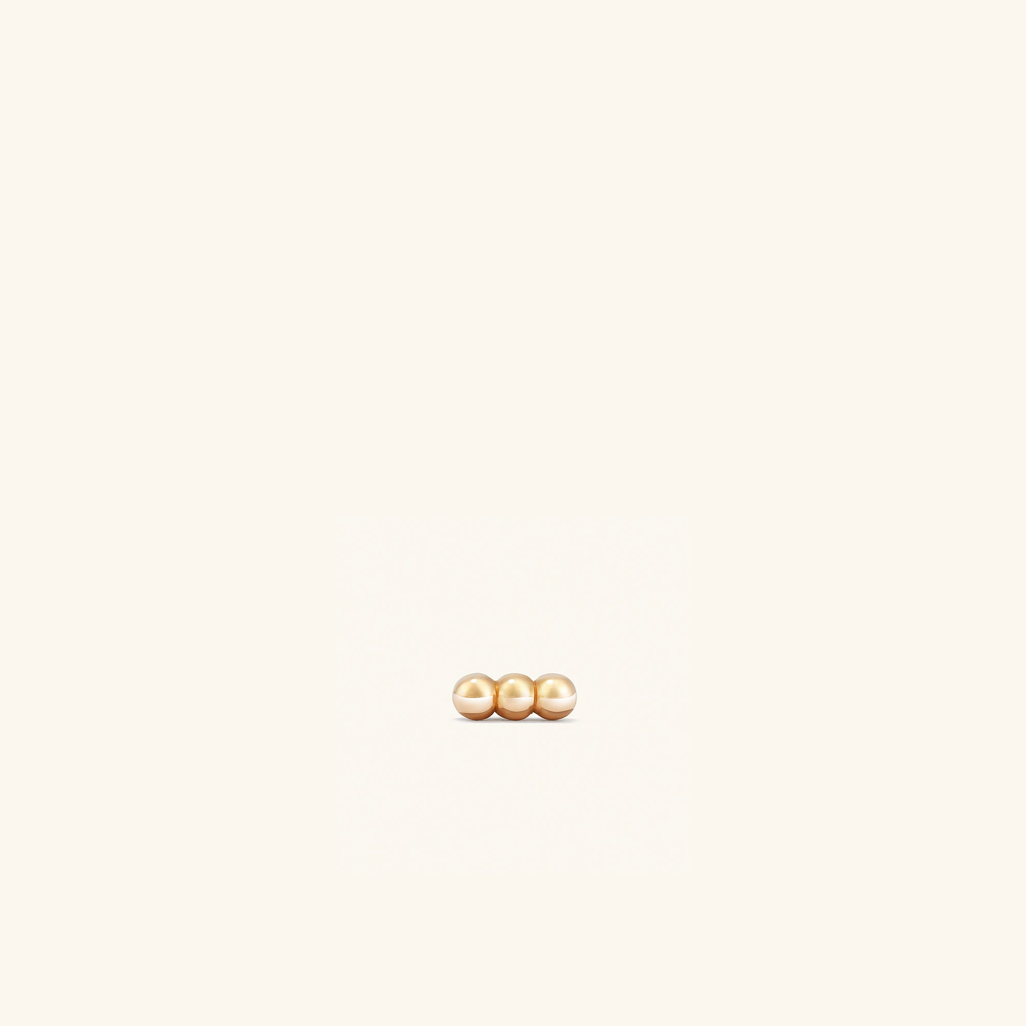 Spheres Bar Stud featuring three gold spheres aligned in a bar design, perfect for stacking horizontally or vertically with comfortable flat back studs.
