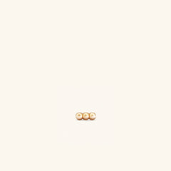 Spheres Bar Stud featuring three gold spheres aligned in a bar design, perfect for stacking horizontally or vertically with comfortable flat back studs.