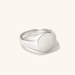 Bold Round Signet Ring: Close-up of a silver ring with a round center, handcrafted in sterling silver, perfect for engraving.