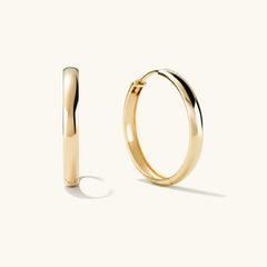 Bold Large Hoops: A pair of handcrafted, recycled 14k solid gold hoop earrings, designed to elevate any outfit.