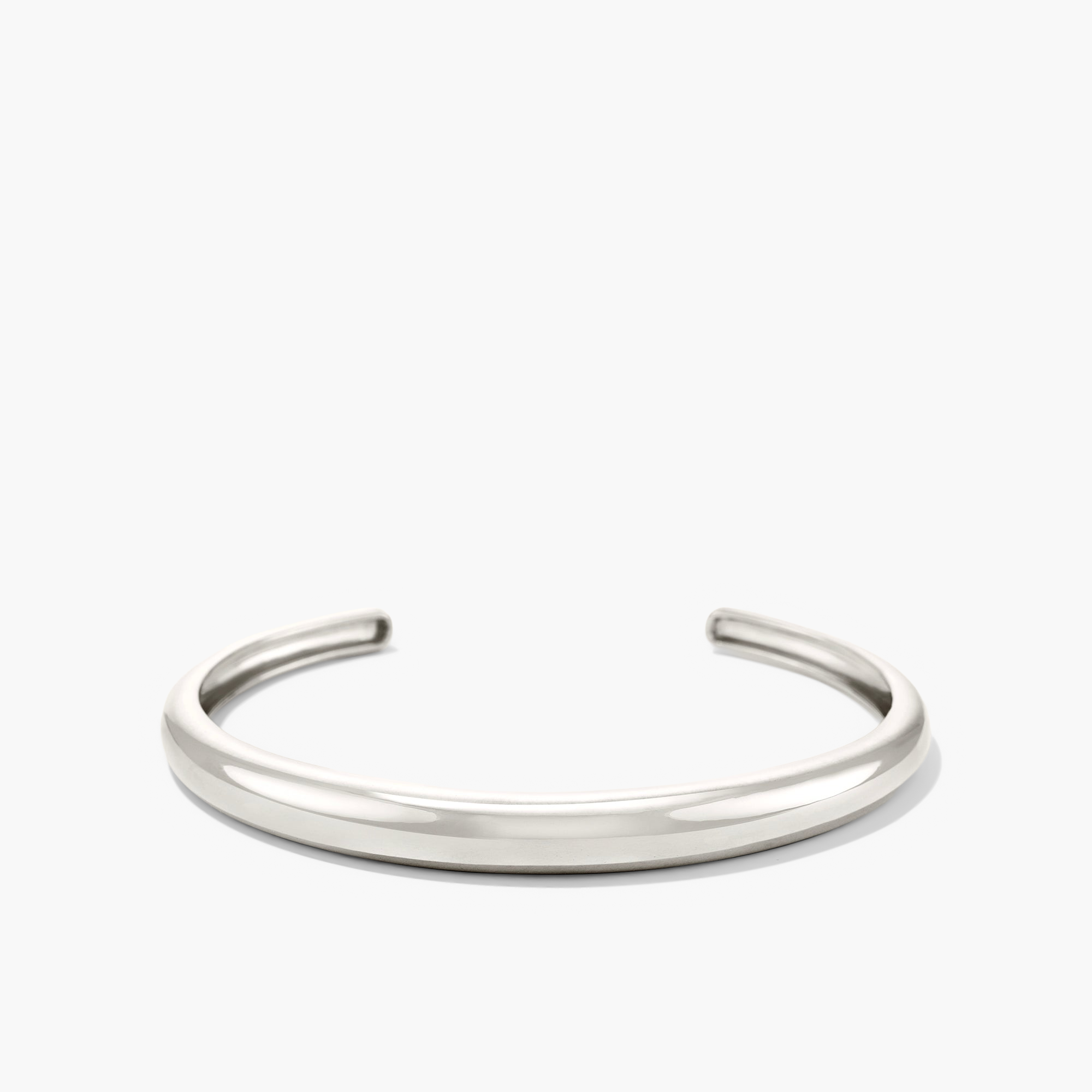 DÃ´me Cuff Bracelet: A sleek, silver bracelet with a minimalist design, inspired by dome architecture, placed against a plain white background.