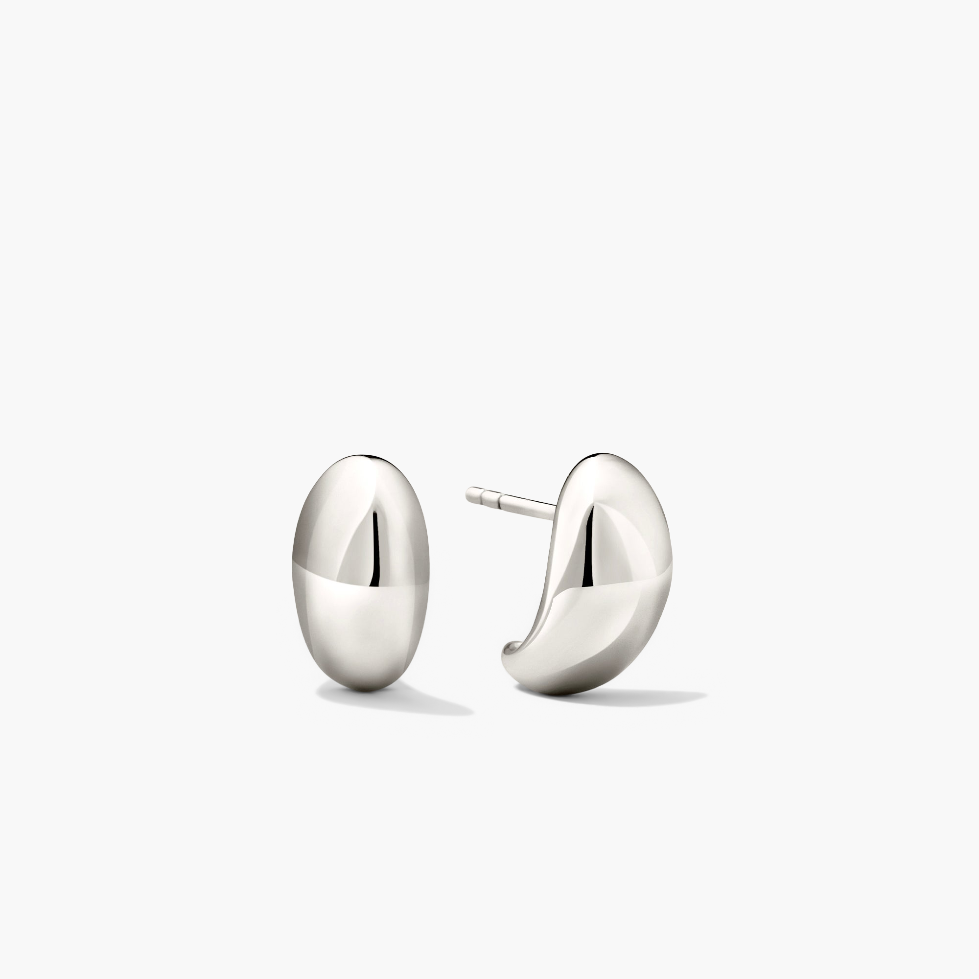 DÃ´me Huggies: Pair of sculptural silver earrings with a curved, lobe-hugging design. Ideal for stacking and everyday wear.