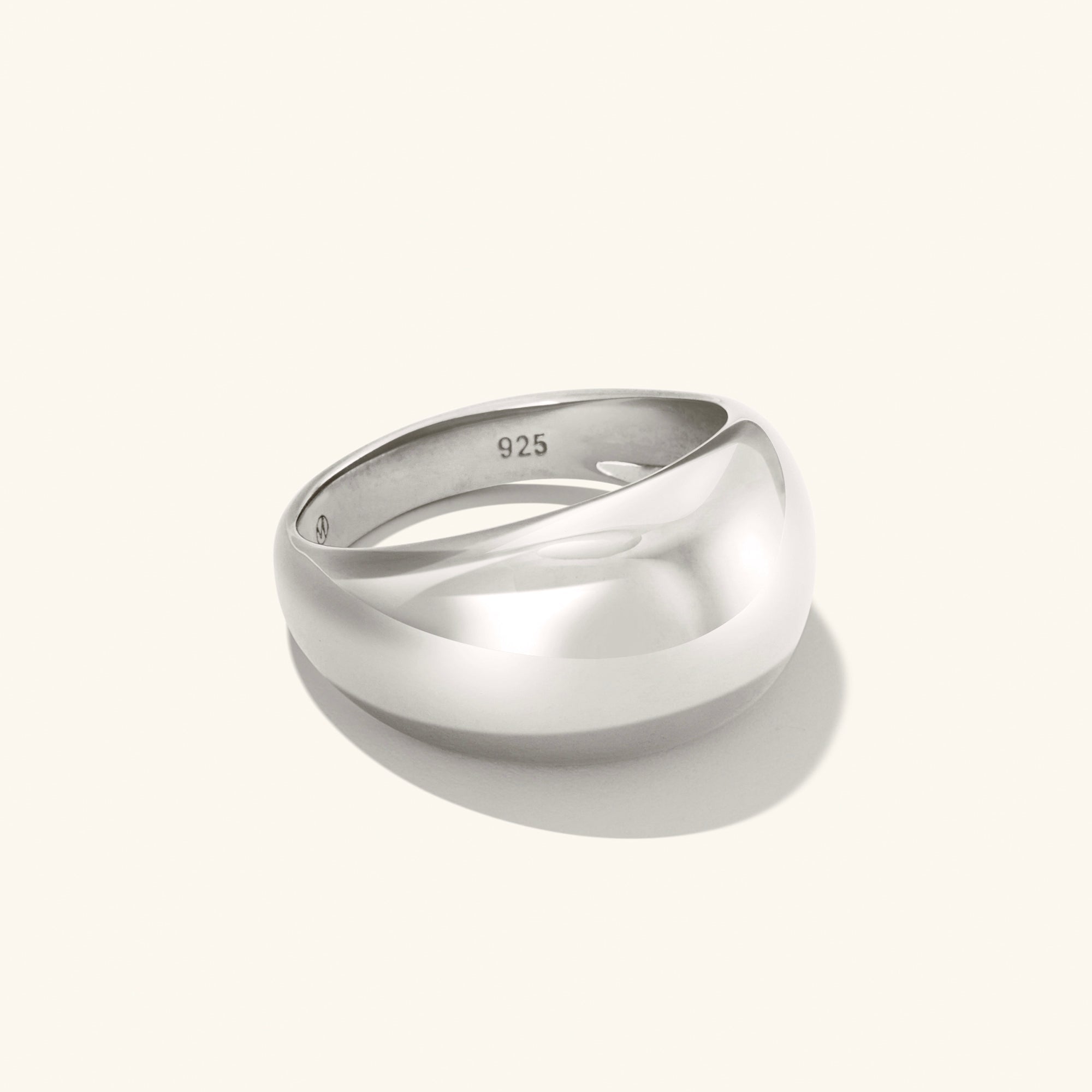 Silver DÃ´me Ring with a polished, curved design casting a shadow. Ideal for stacking with delicate rings for a bold, classic look.