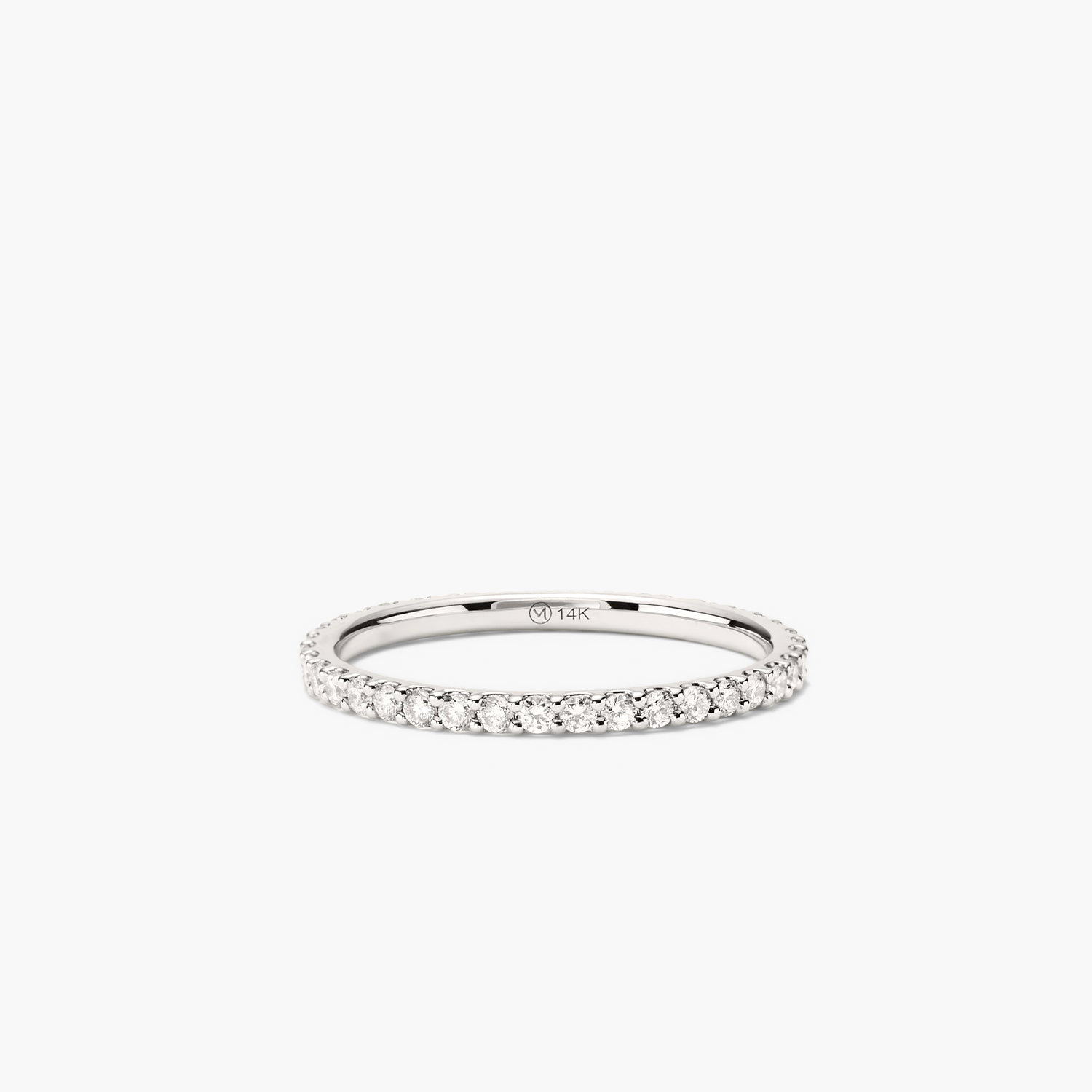 Diamond Eternity Band: A close-up of a slim silver ring featuring hand-set diamonds in open prongs, showcasing its intricate design and sparkle.