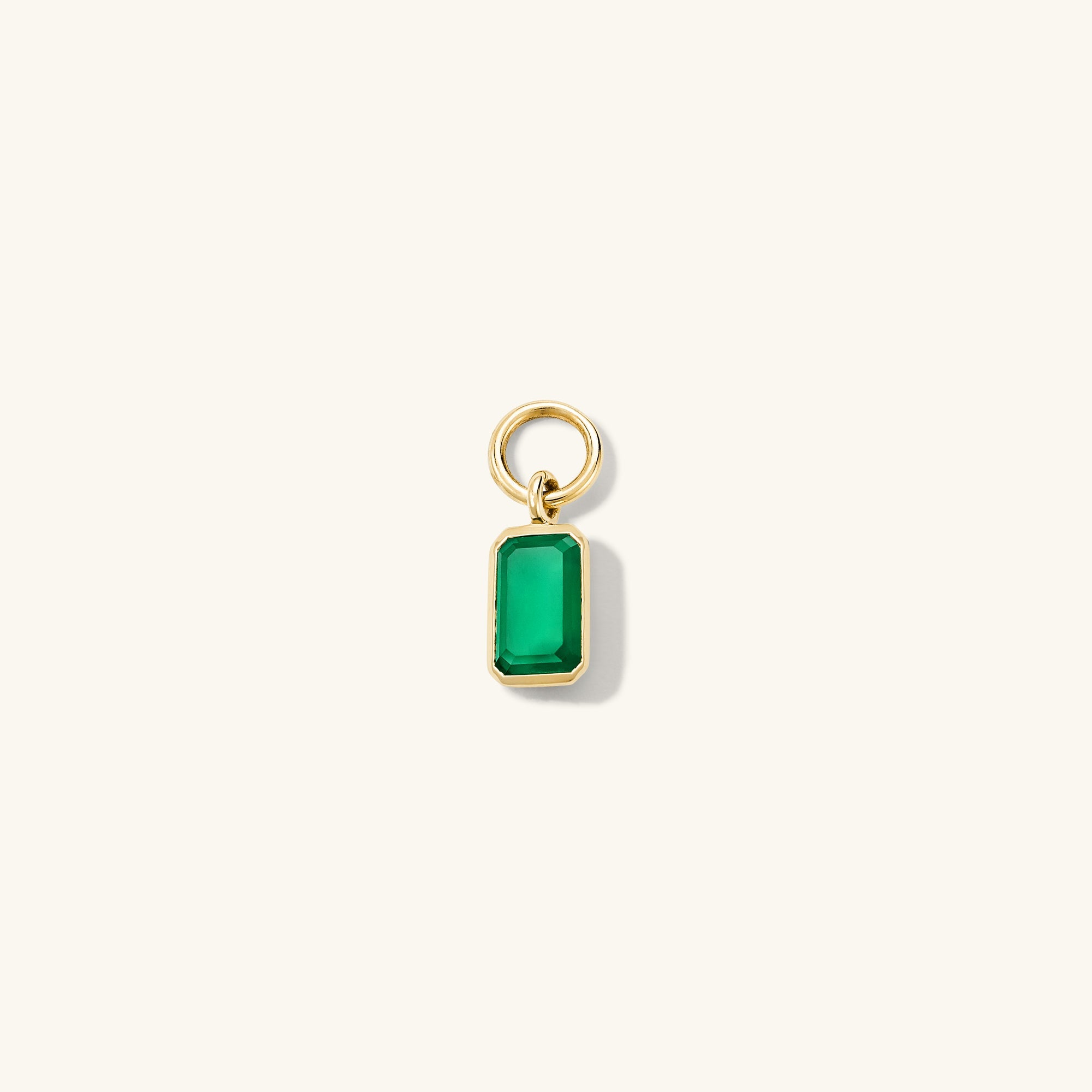 Close-up of a Single Emerald Cut Gemstone Hoop Charm showcasing a green gem set in a gold ring, perfect for personalizing hoop earrings.