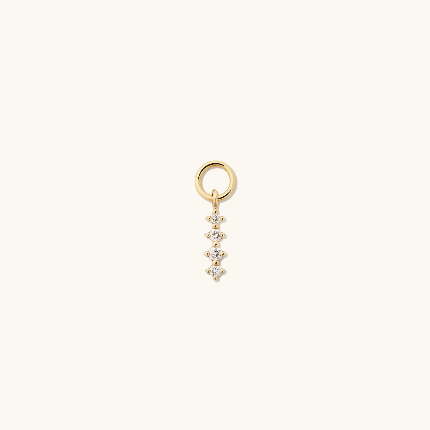 Close-up of the Single Diamond Icicle Hoop Charm, featuring a gold pendant designed to enhance everyday hoops with a touch of elegance.