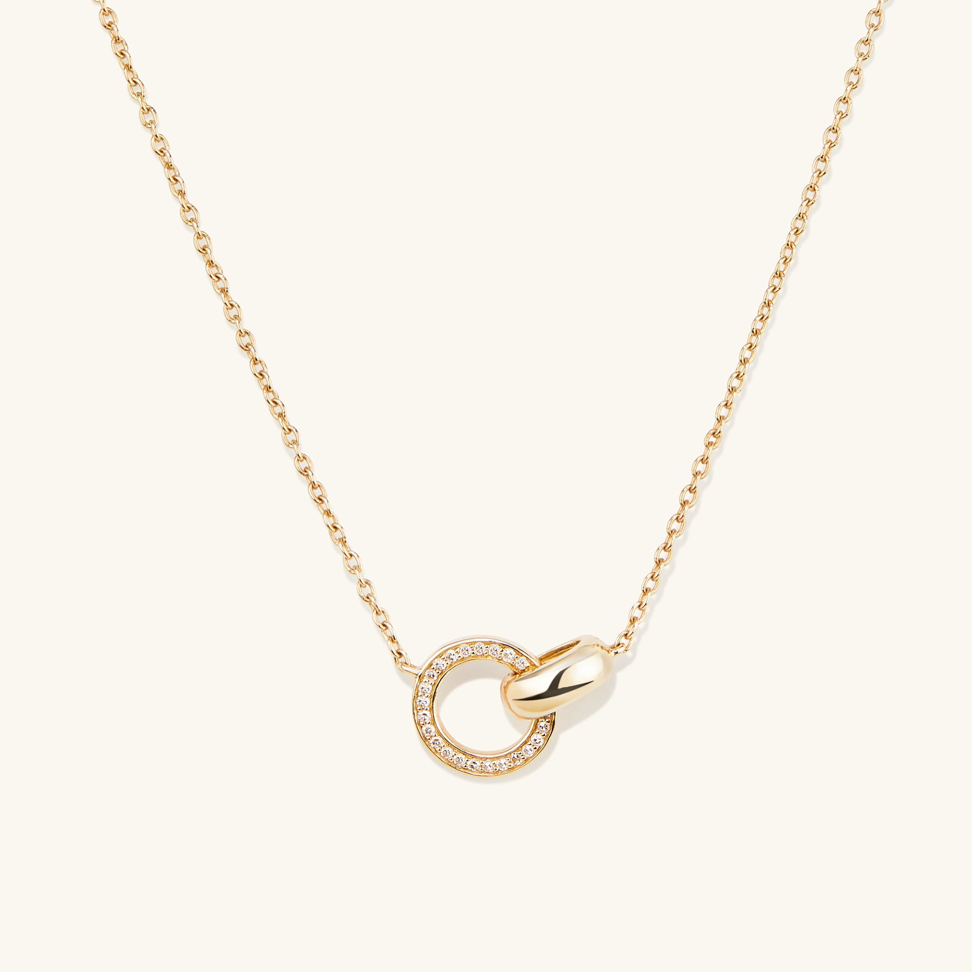 PavÃ© Diamond Linked Necklace: a 14k gold chain featuring two interlinked rings, one adorned with Kimberley Process compliant diamonds, symbolizing personal bonds.
