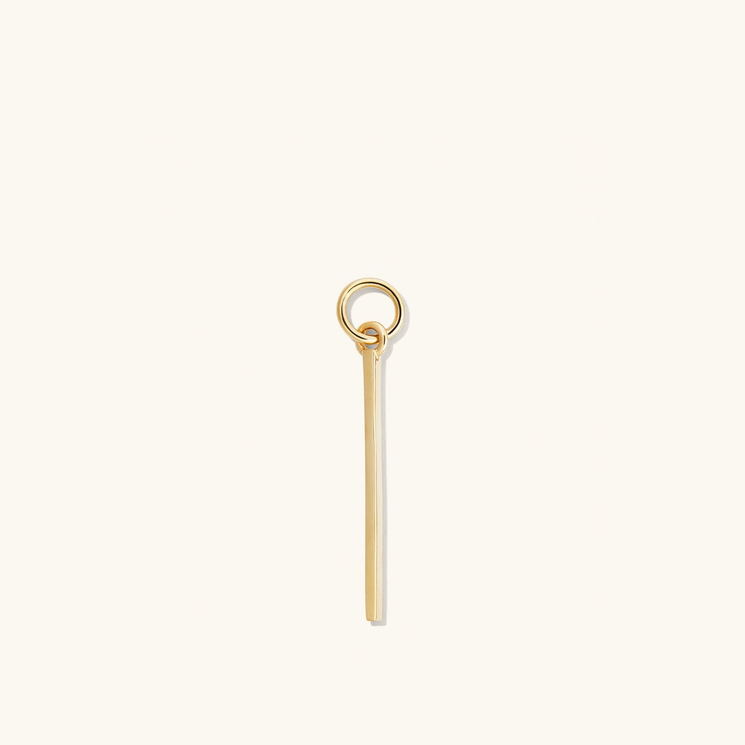 Single Bar Hoop Charm: A close-up of a gold key-shaped charm designed to be added to hoop earrings for a personalized, high-impact look.
