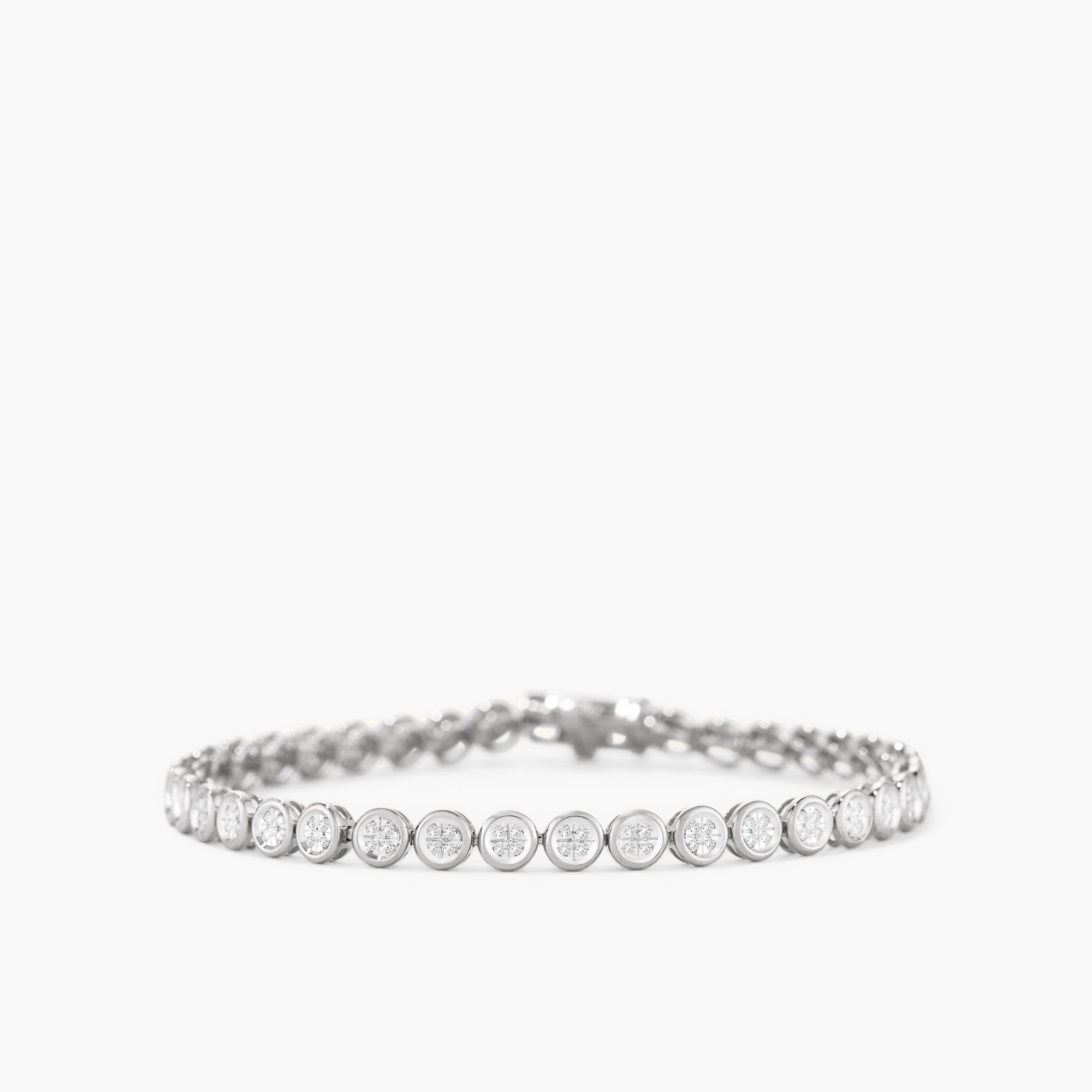 Micro-PavÃ© Diamond RiviÃ¨re Bracelet: a close-up of a silver bracelet adorned with numerous small, knife-edge bezel-set diamonds, showcasing intricate craftsmanship.