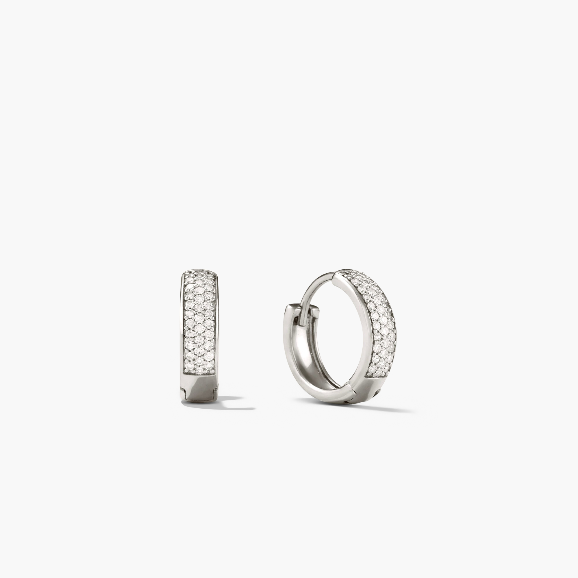 Bold PavÃ© Diamond Huggie Hoops: A pair of 14k solid gold earrings adorned with responsibly sourced diamonds, showcasing a sparkling and elegant design.
