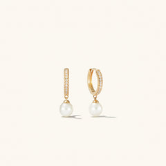 PavÃ© Diamond Pearl Huggies: 14k gold earrings with 22 pavÃ©-set diamonds and a round freshwater pearl, elegantly designed for versatile wear.